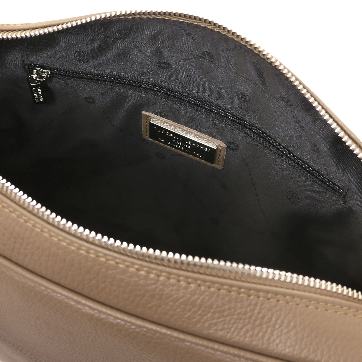 Close-up of a taupe leather bag with a zipper, showing the black interior and zip pocket