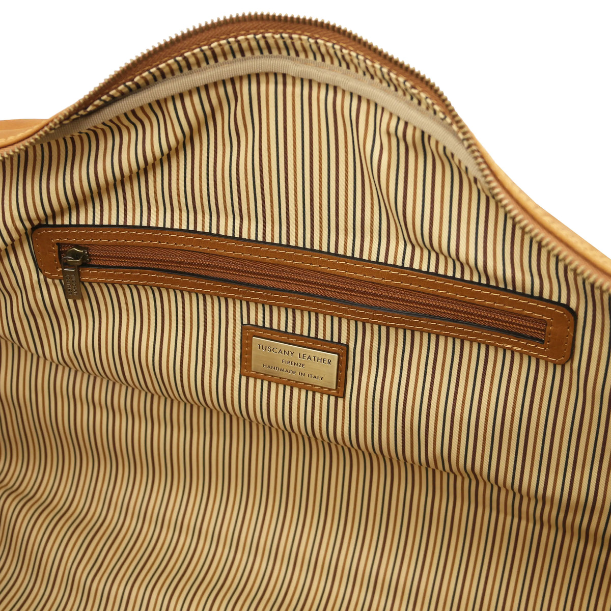 Close-up of a striped interior lining with a brown zipper and visible brand label.