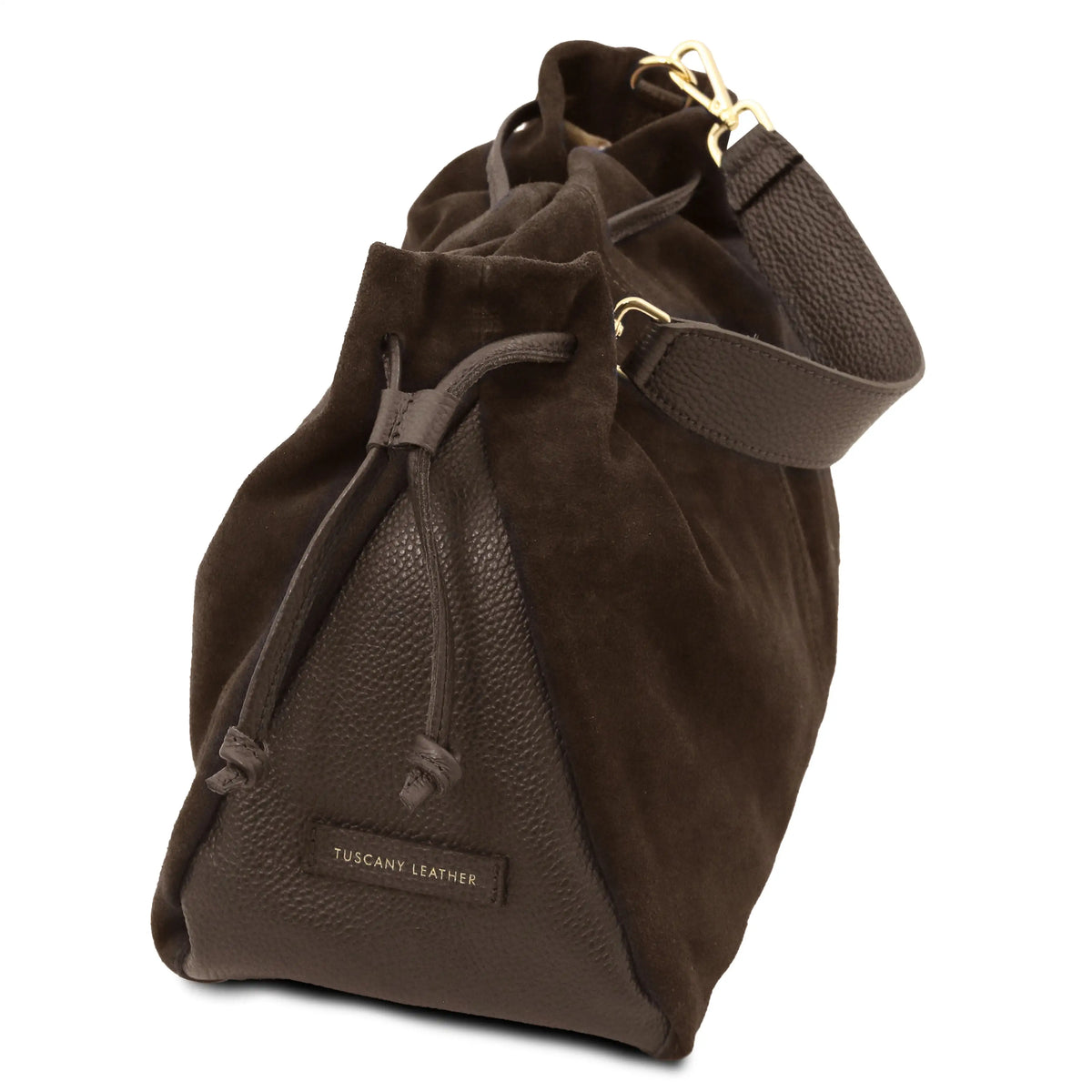 A dark brown leather bucket bag with a pebbled texture, featuring a suede-like drawstring top, a matching shoulder strap, and a small 'TUSCANY LEATHER' brand label on the side.