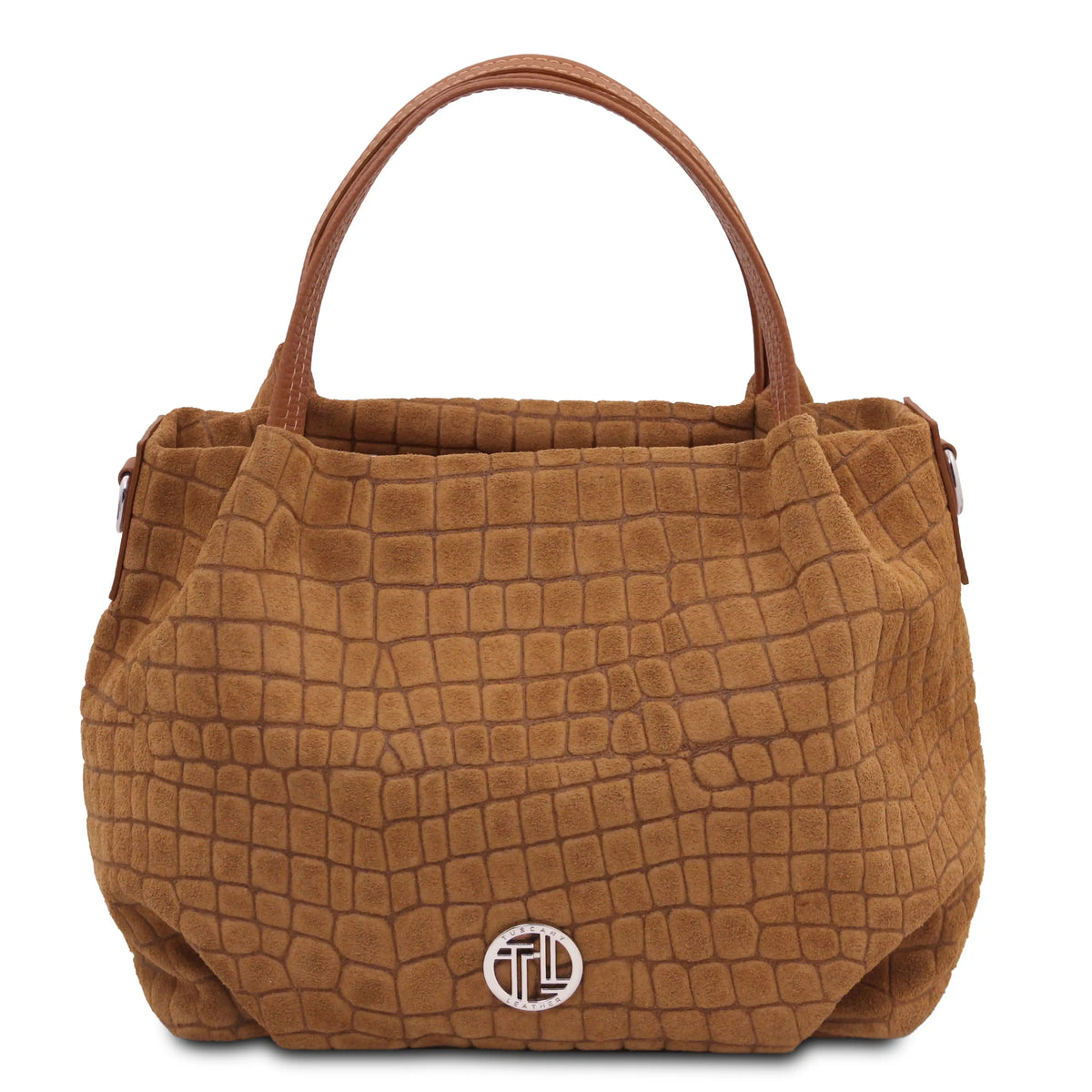 A brown textured handbag with a crocodile-embossed pattern, featuring dual top handles and a silver-toned circular logo medallion on the front, set against a plain white background.