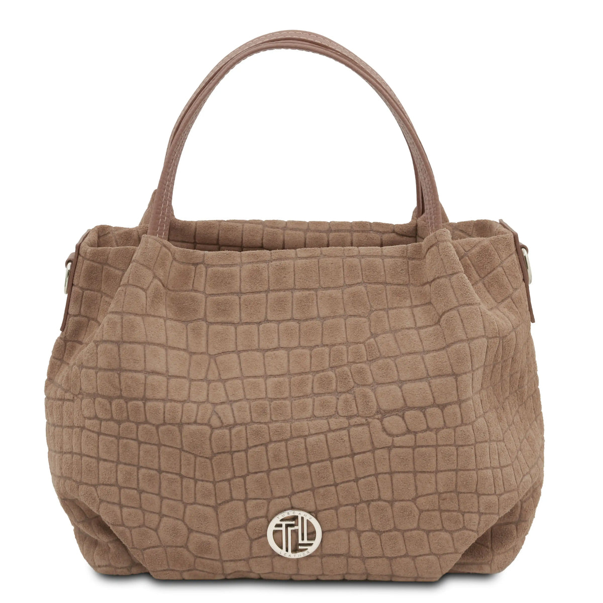 A taupe brown crocodile-embossed leather handbag with dual top handles and a silver-tone circular logo medallion on the front, set against a plain white background.