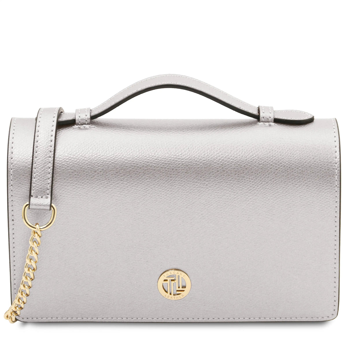 A light silver leather handbag with a top handle, a detachable gold-tone chain strap, and a circular gold-tone logo medallion on the front.