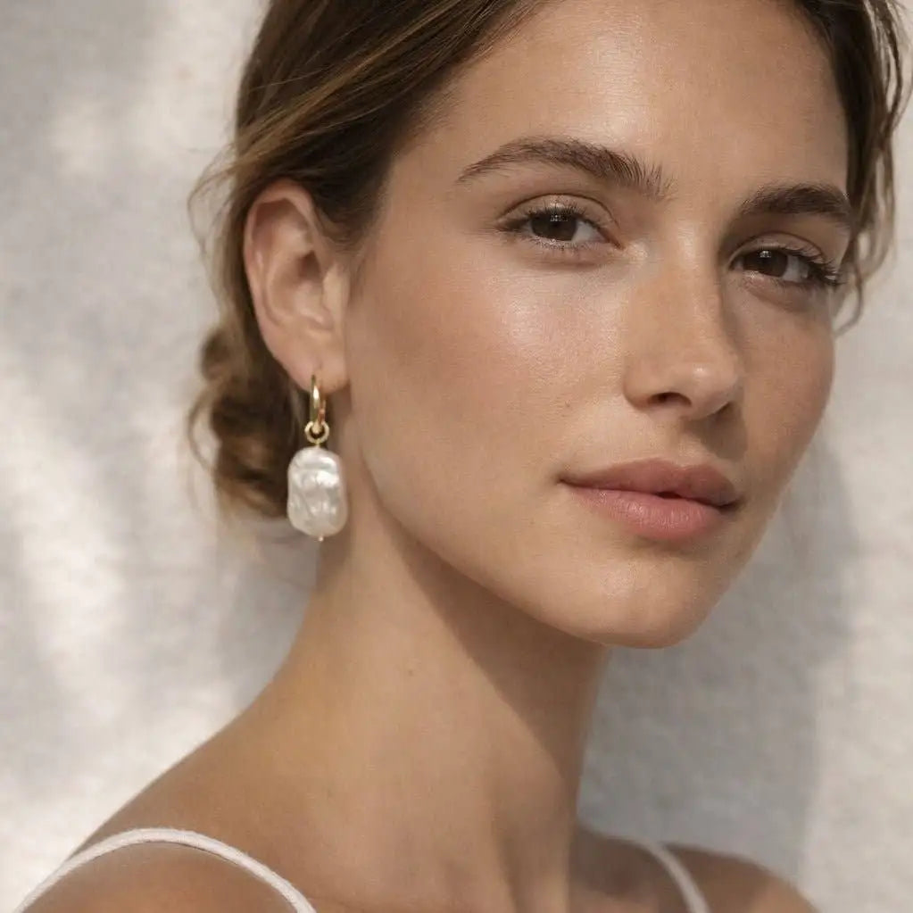 A woman is wearing the Amalfi Aurora 2-in-1 Hoop Earrings 