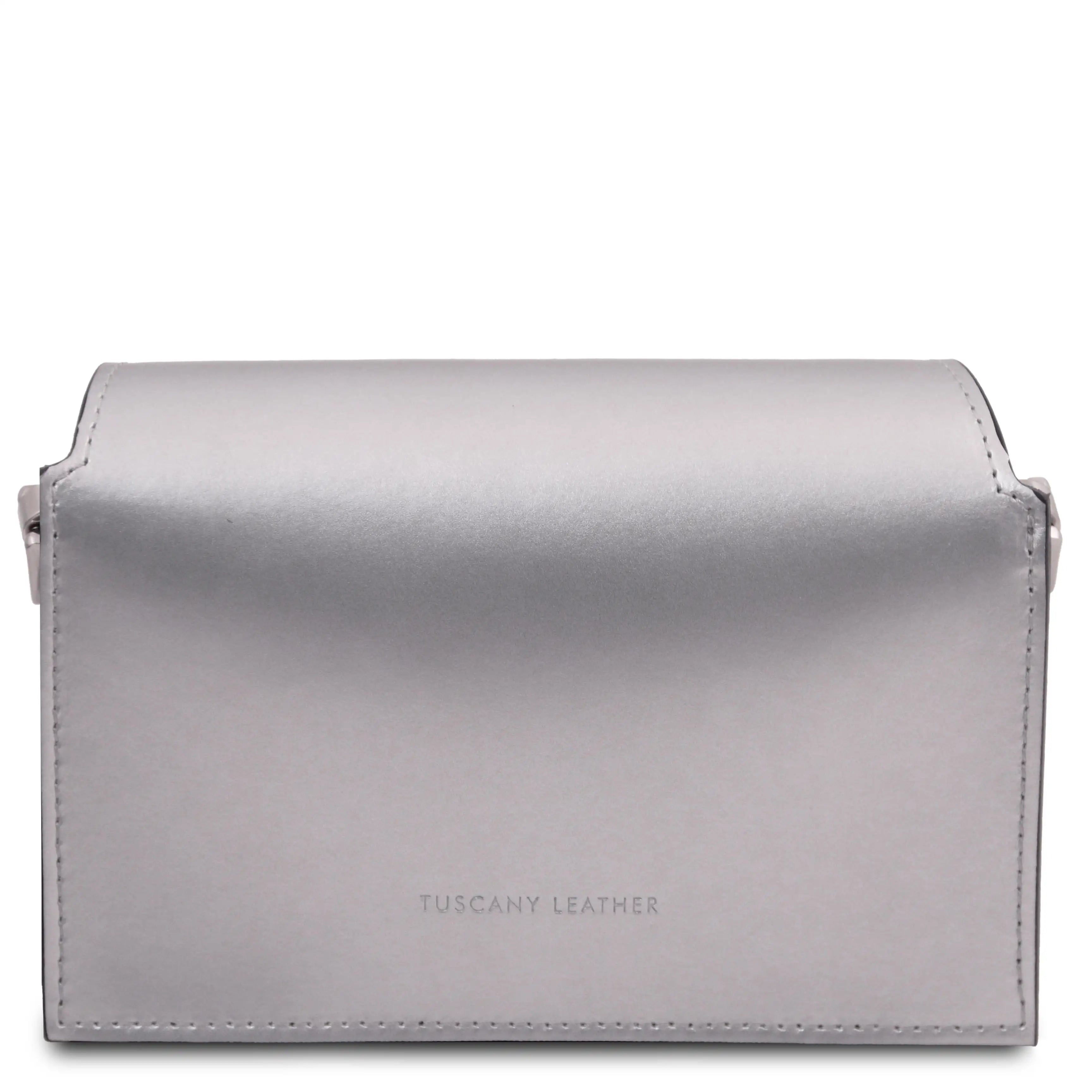 A metallic silver leather shoulder bag with a curved top flap and the embossed text 'TUSCANY LEATHER' on the back, set against a plain white background.