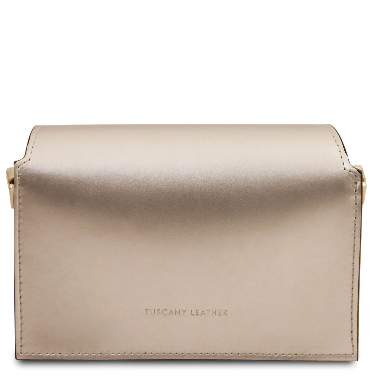 A metallic champagne gold leather crossbody bag with gold-tone hardware, featuring the debossed brand name 'TUSCANY LEATHER' on the bottom, set against a plain white background.