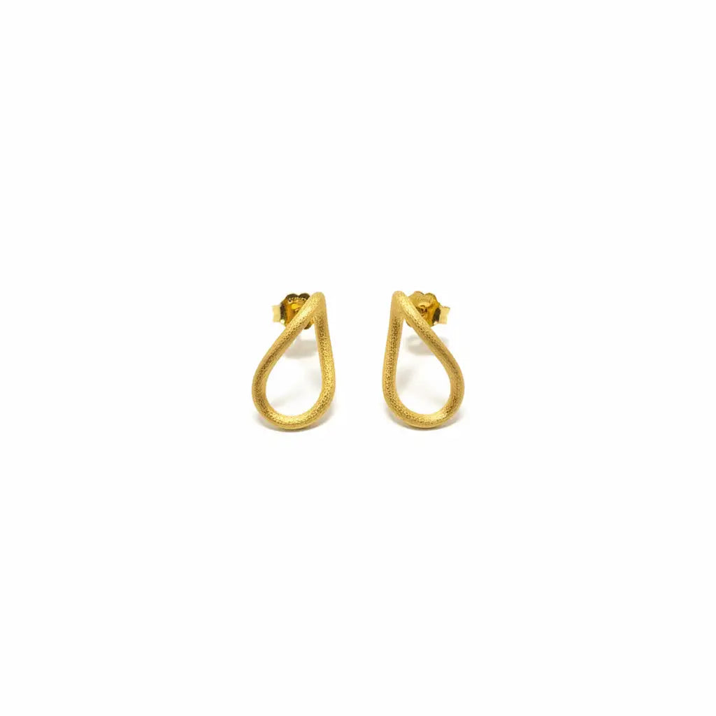 A pair of textured and sculptural gold teardrop earrings on a clean white background.