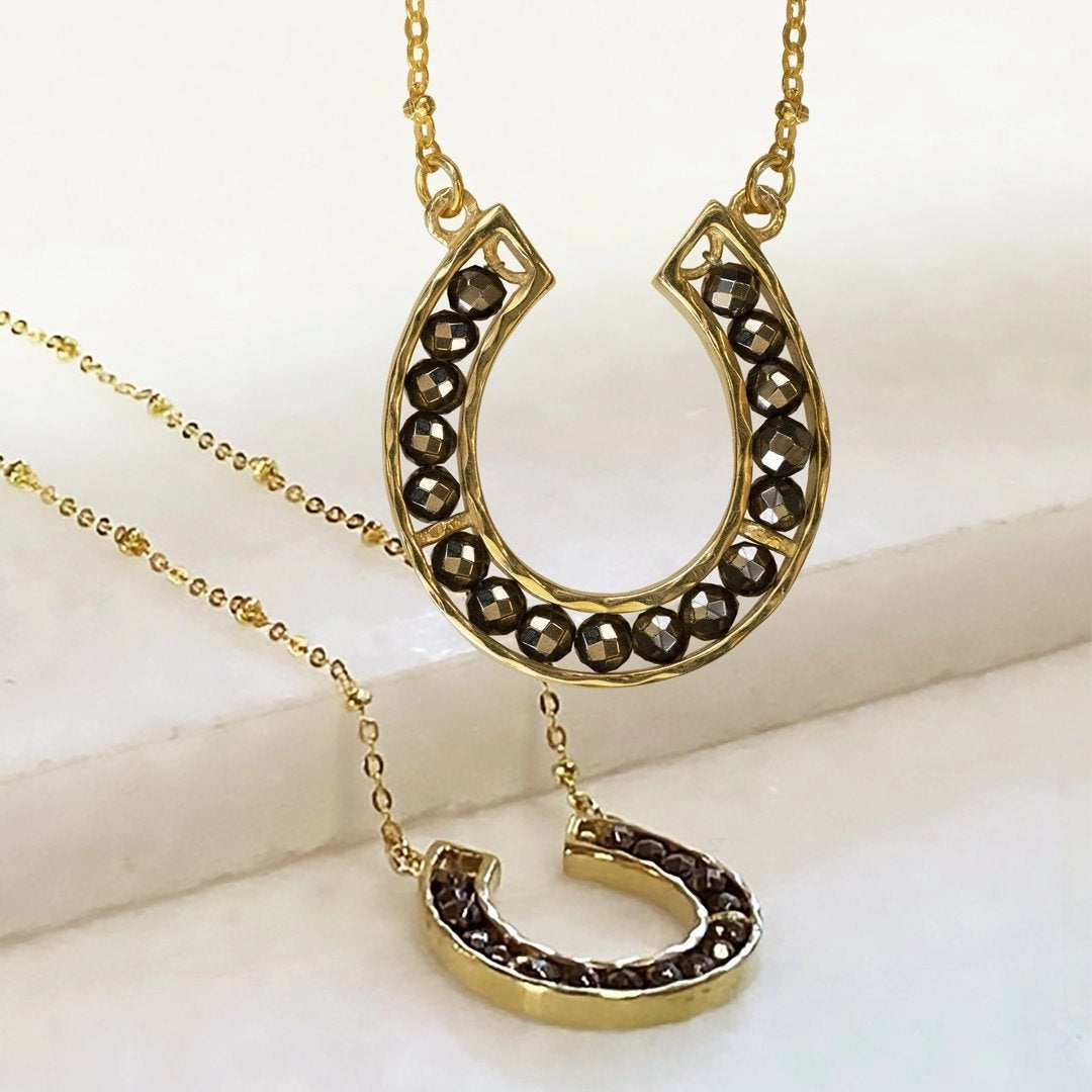 Our Capriole Horseshoe Pyrite Necklace. Hues of brown translucent Pyrite set in luscious gold.