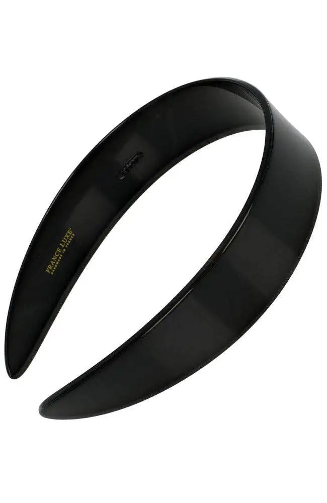 A glossy black wide headband on a plain white background.