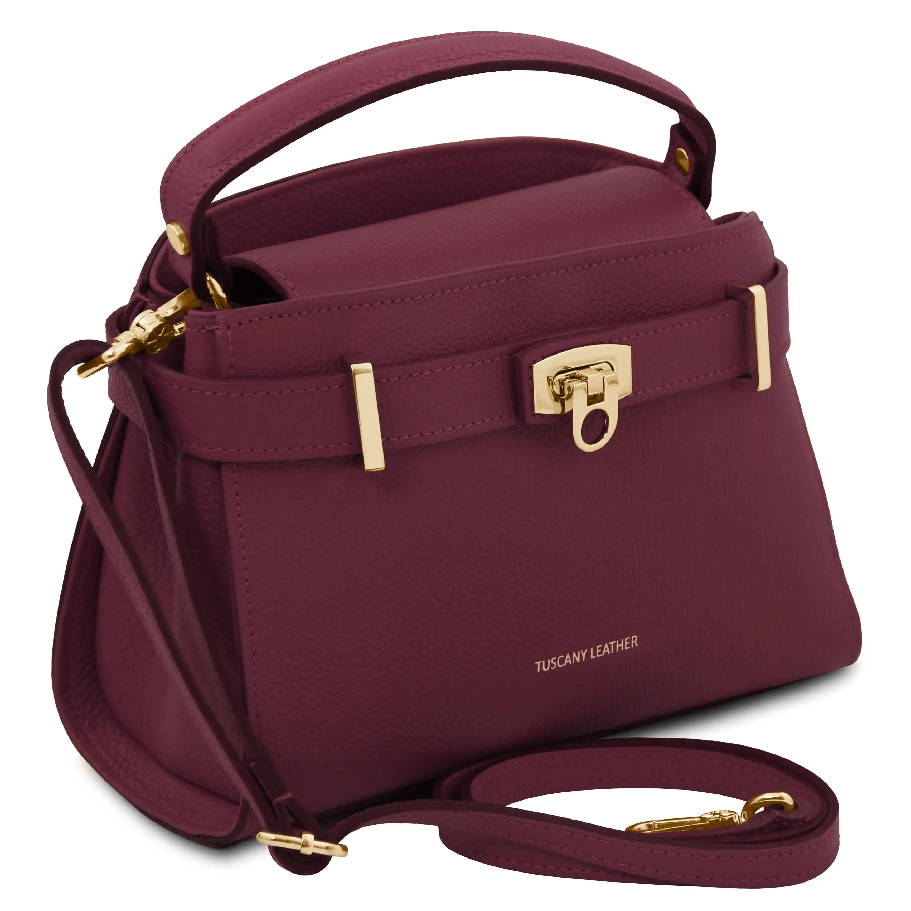 Bordeaux handbag with gold accents on a white background
