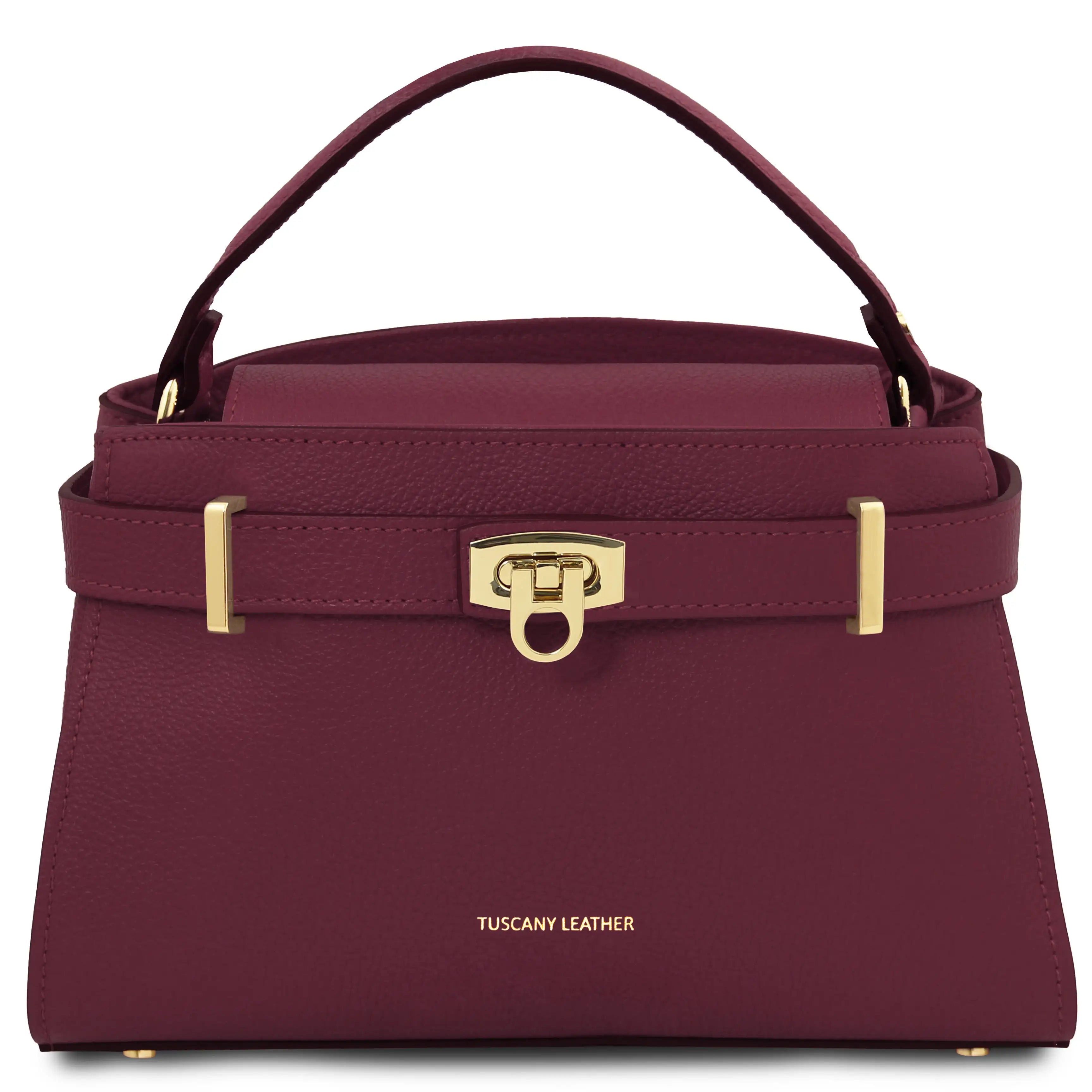 Bordeaux  handbag with gold accents on a white background