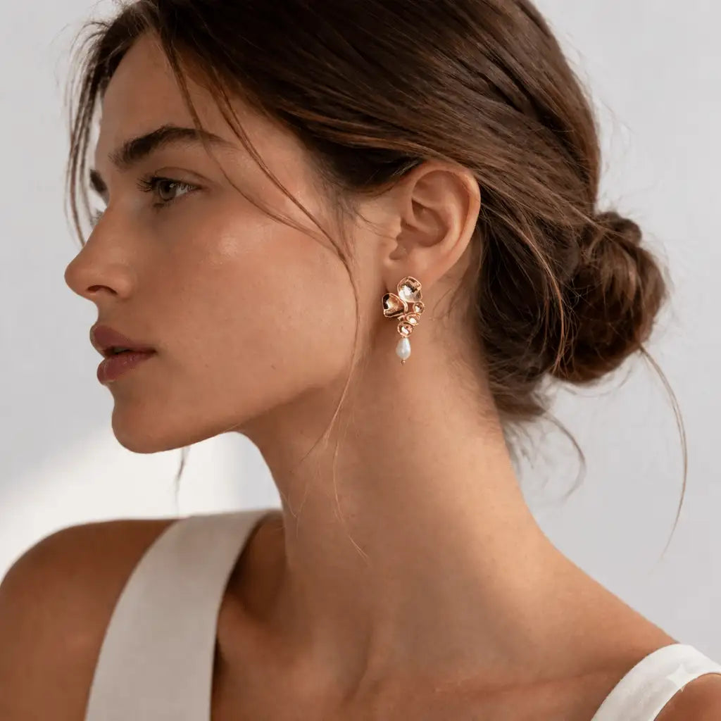 Profile image of a woman with her hair in the bun wearing the Amalfi Golden Petal Drop Earrings 