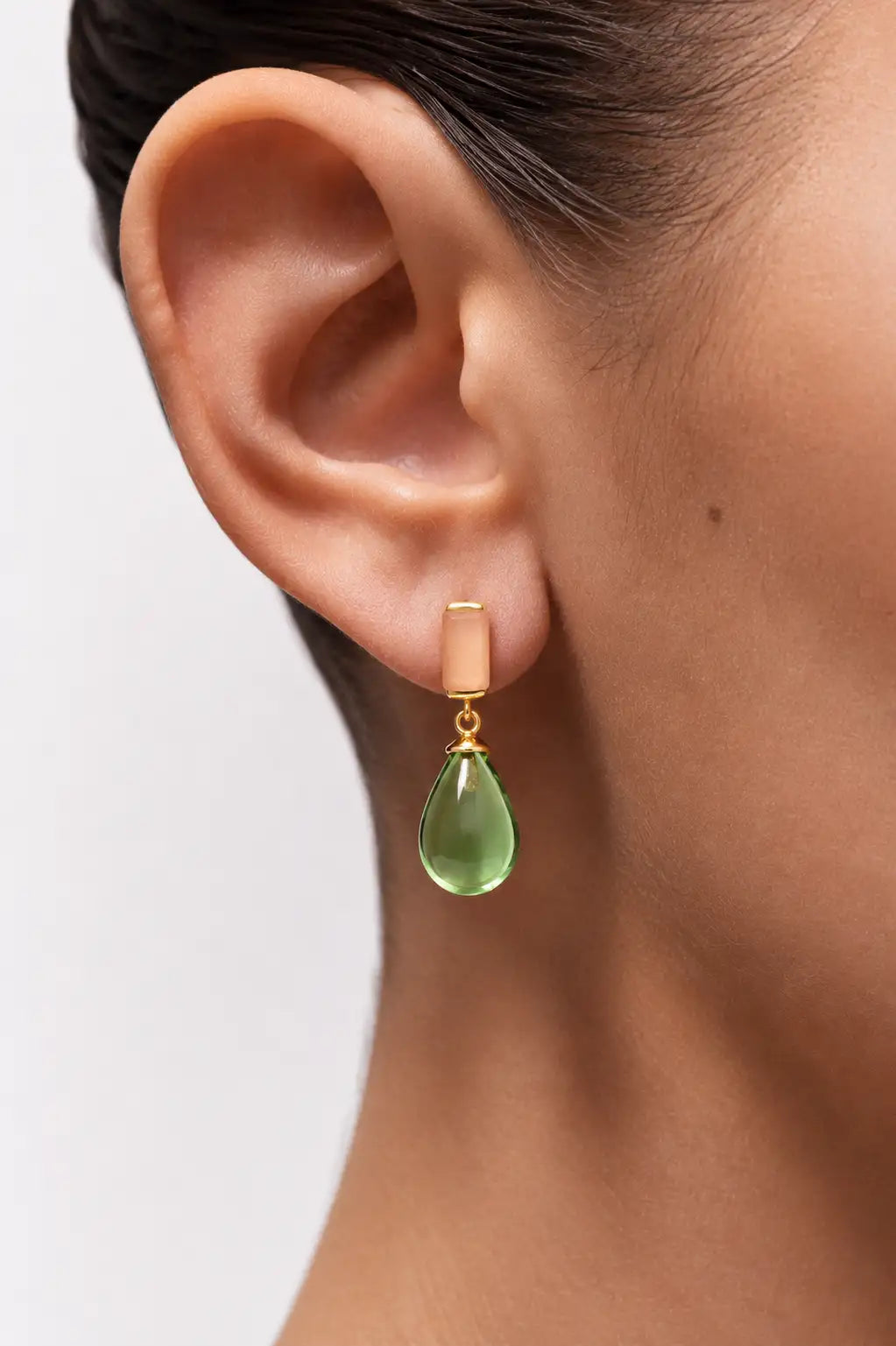 Close up view Gracelyn Drop Peach Moonstone & Green Quartz Earrings on a women's right ear
