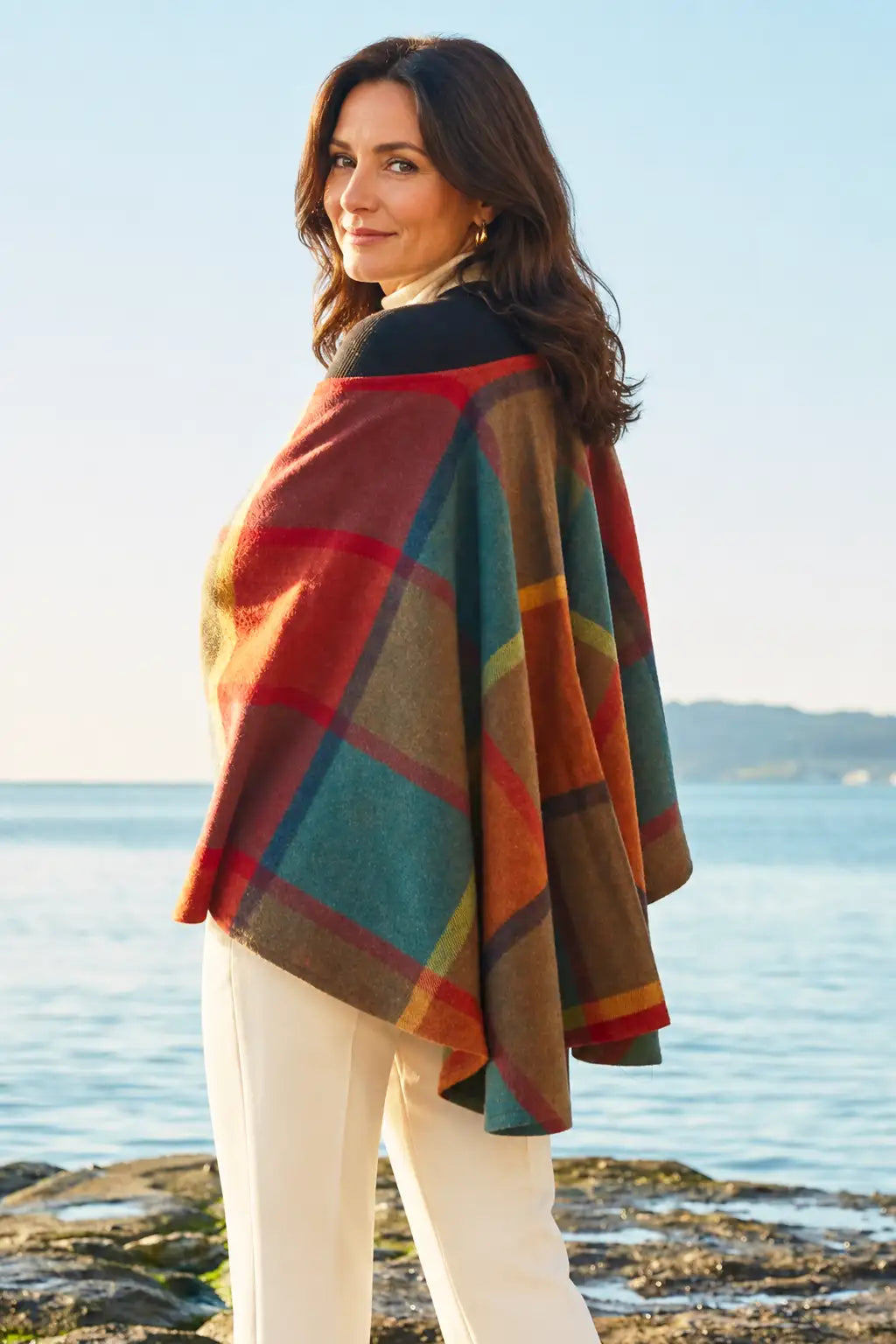 Woman wearing a Harlequin Melange Ruana Wrap  by the sea