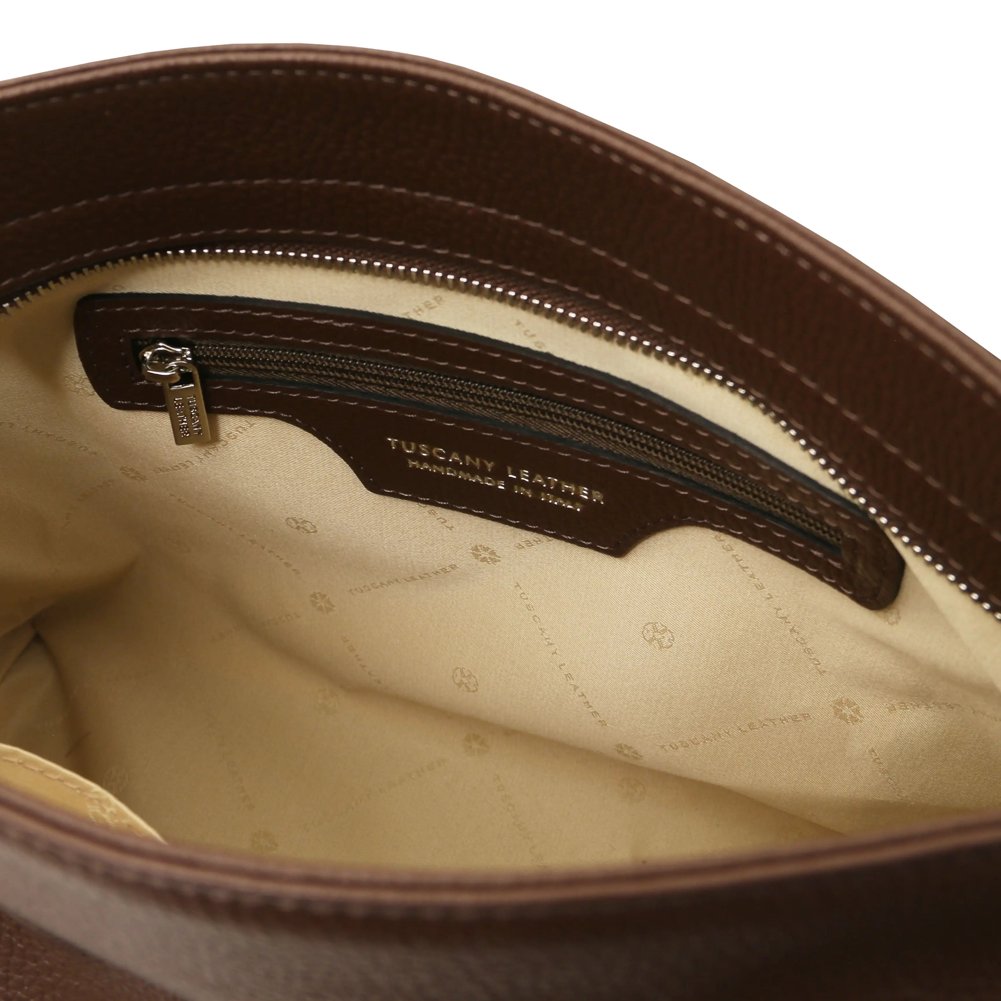 Interior view of the TL Bag Soft Leather Handbag in Chocolate with a zippered pocket and beige lining on a white background.