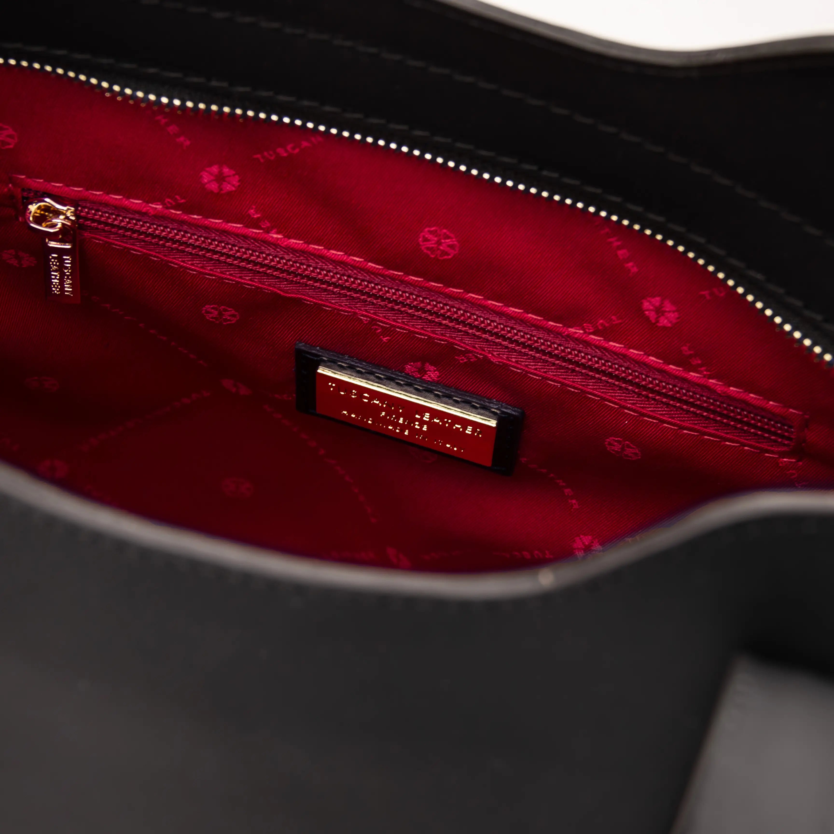 Interior zip pockets red lining view Olimpia Leather Tote Bag in Black