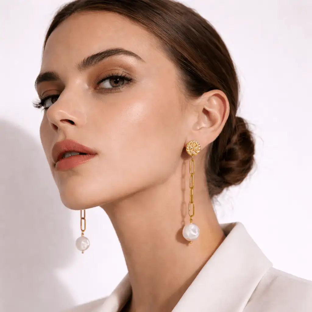 Close up of a woman with her brown hair in a bun wearing the Isabel Drop Earrings 