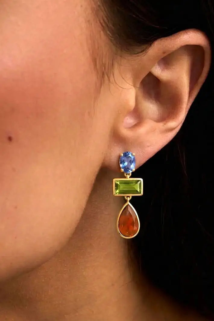 Left profile of a woman wearing the Millie Earrings in Blue Iolite & Green Tourmaline.