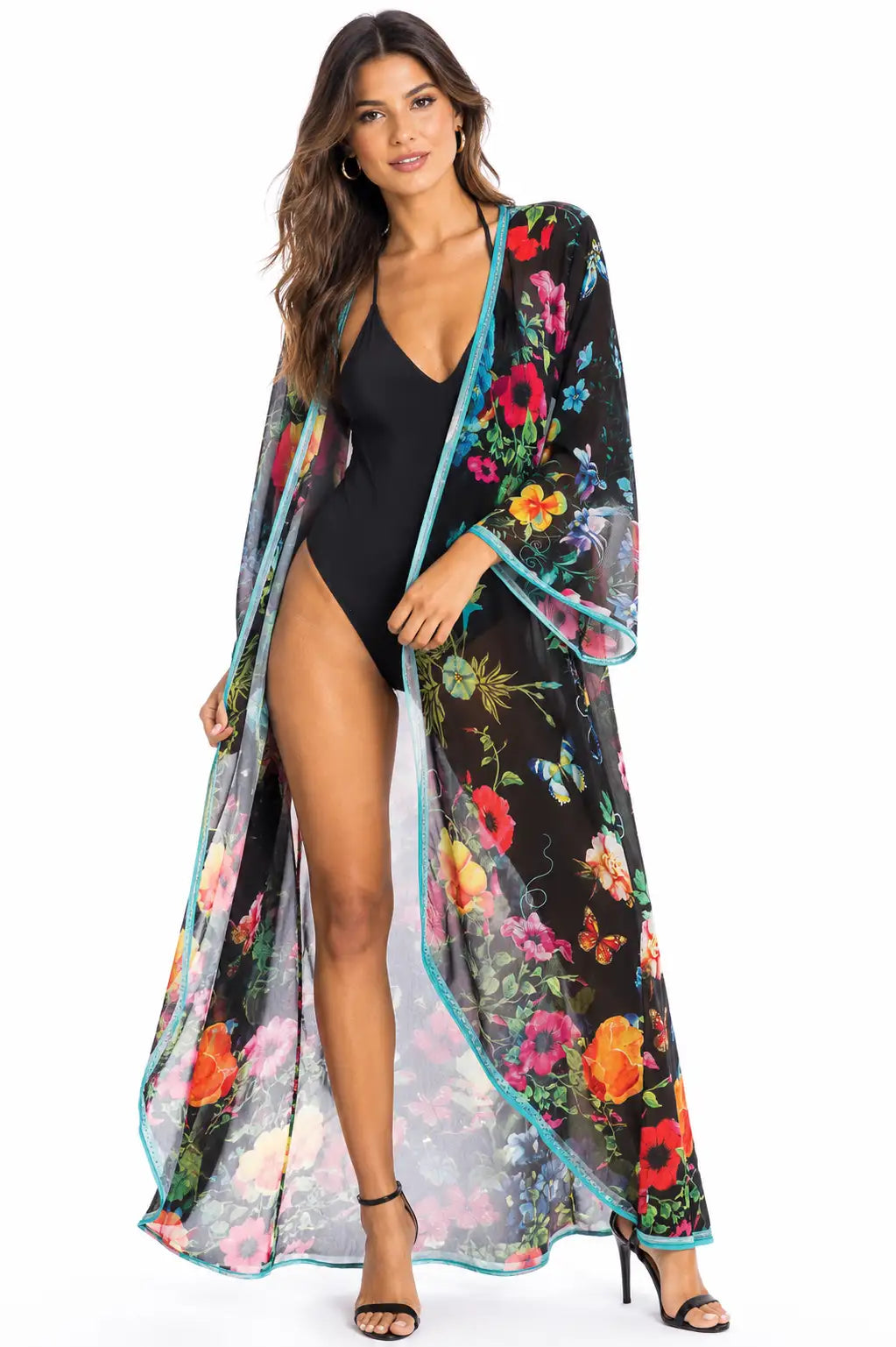 Woman wearing a black swimsuit with a colorful floral cover-up on a white background