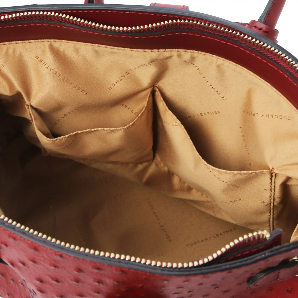 Red leather ostrich print handbag with interior open pockets and beige lining  on a white background
