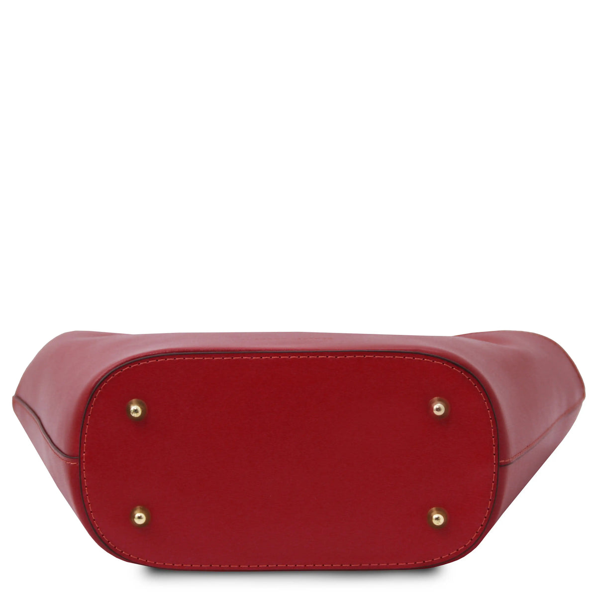 A close-up of a red leather handbag bottom showing the base with four gold-tone metal studs on a white background.