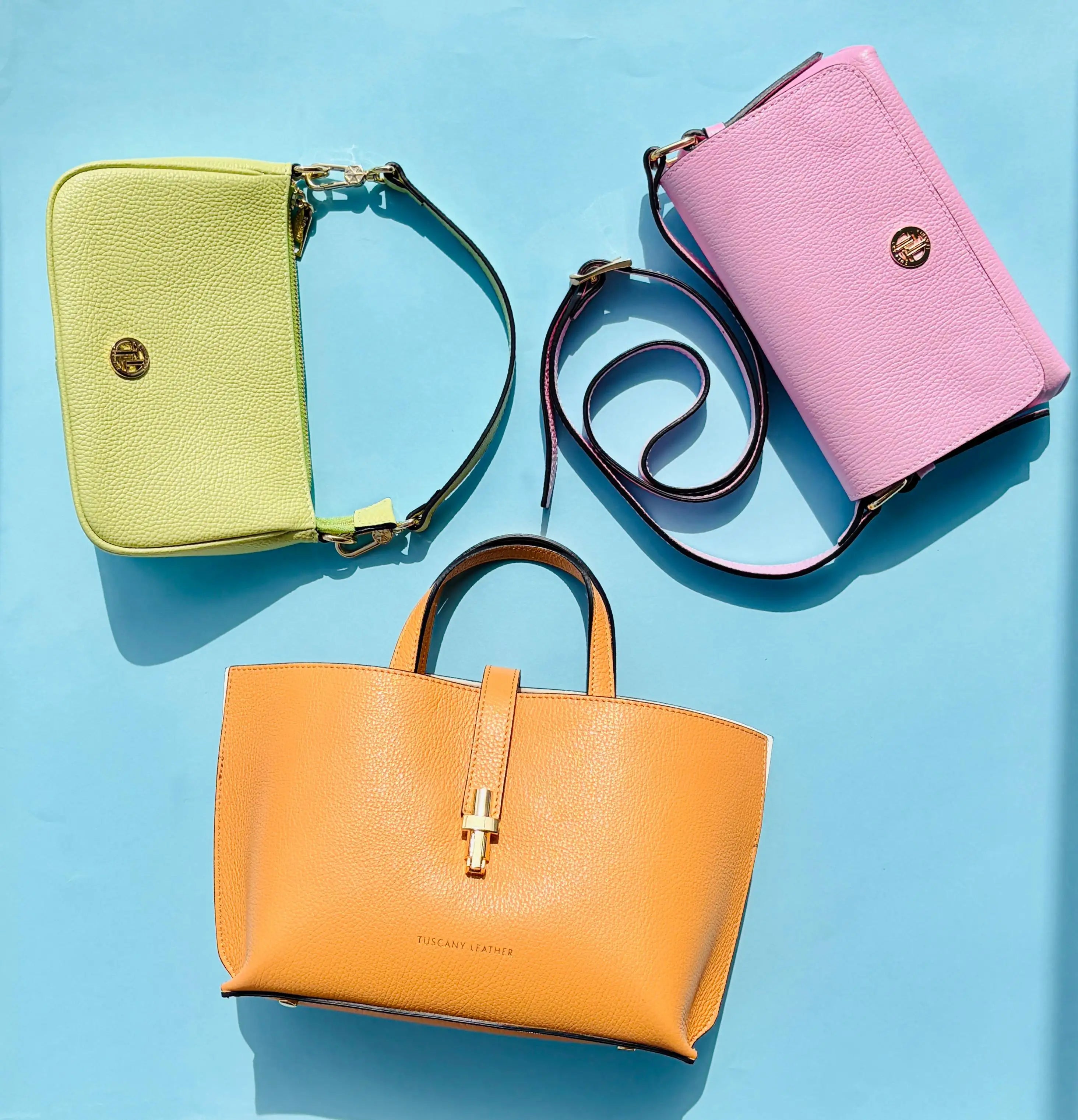 Three colorful Italian handbags on a blue background