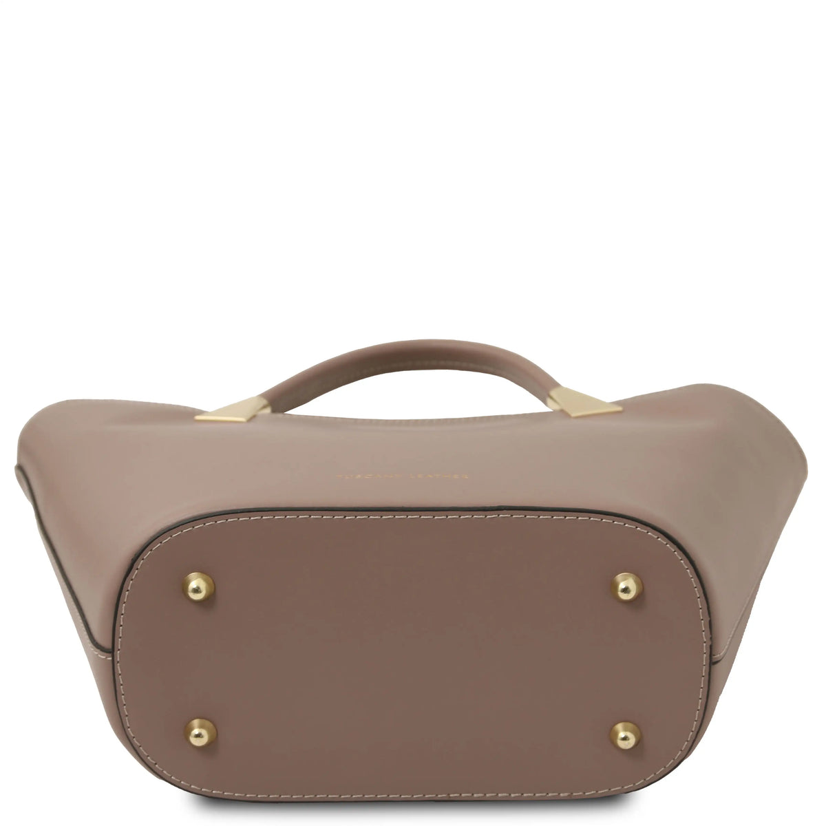 A taupe leather handbag shown from the bottom, featuring a curved top handle with gold-tone metal hardware and four gold-tone studs on the front panel, set against a plain white background.