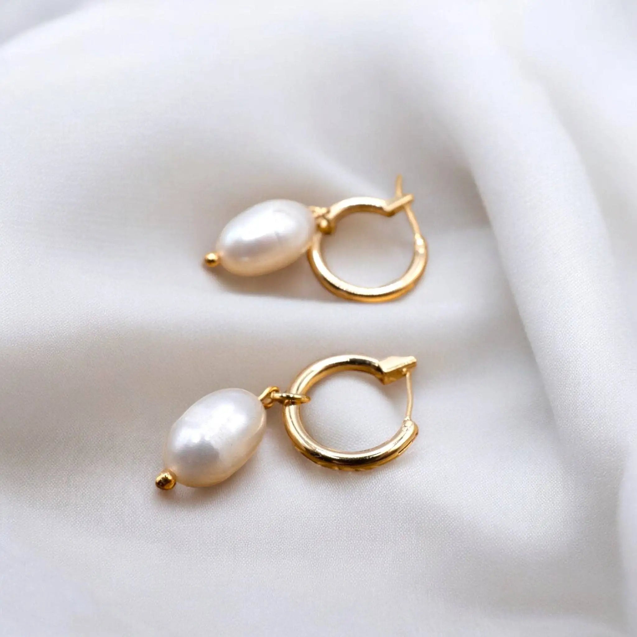 Villa D’Este Small Hoop Pearl Earrings on a white silk  background