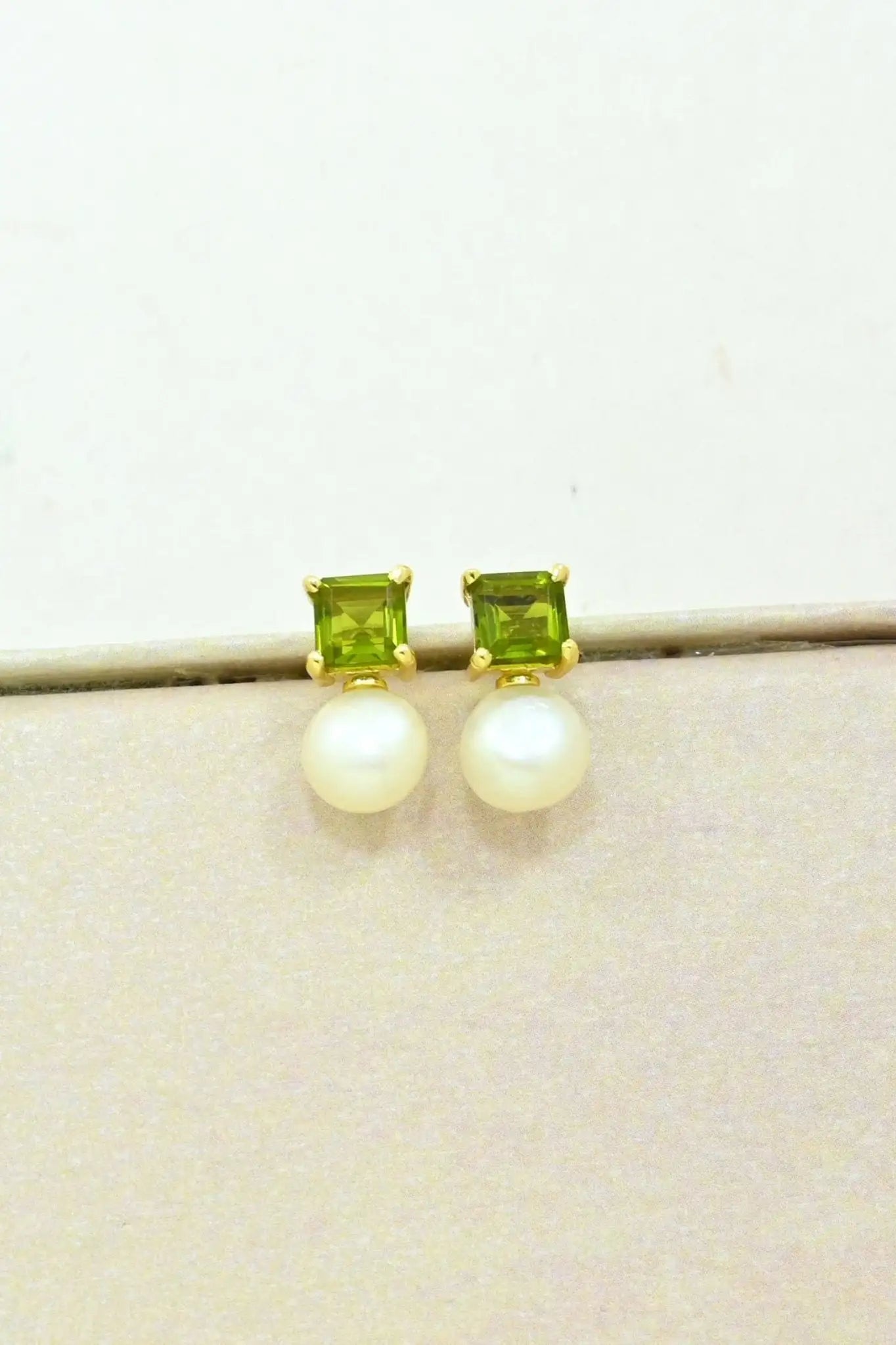 Aaliyah Stud Earrings Pearl & Green Tourmaline on a white background on a natural background