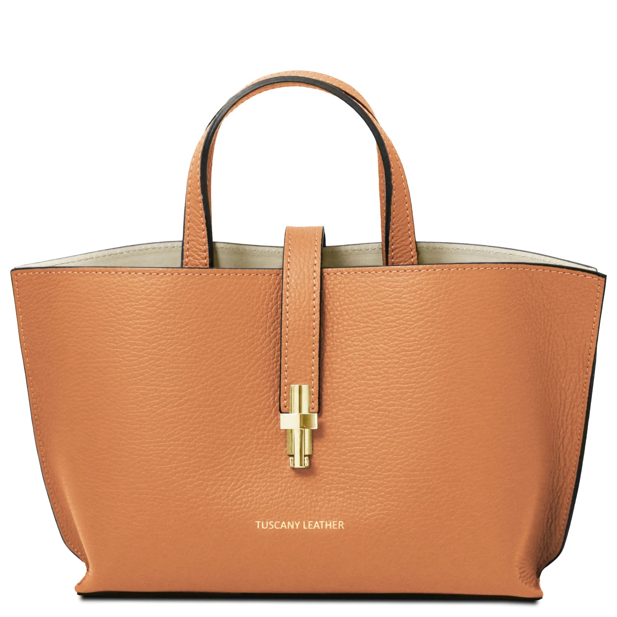 Apricot handbag with gold clasp on white background, Tuscany Leather branding.