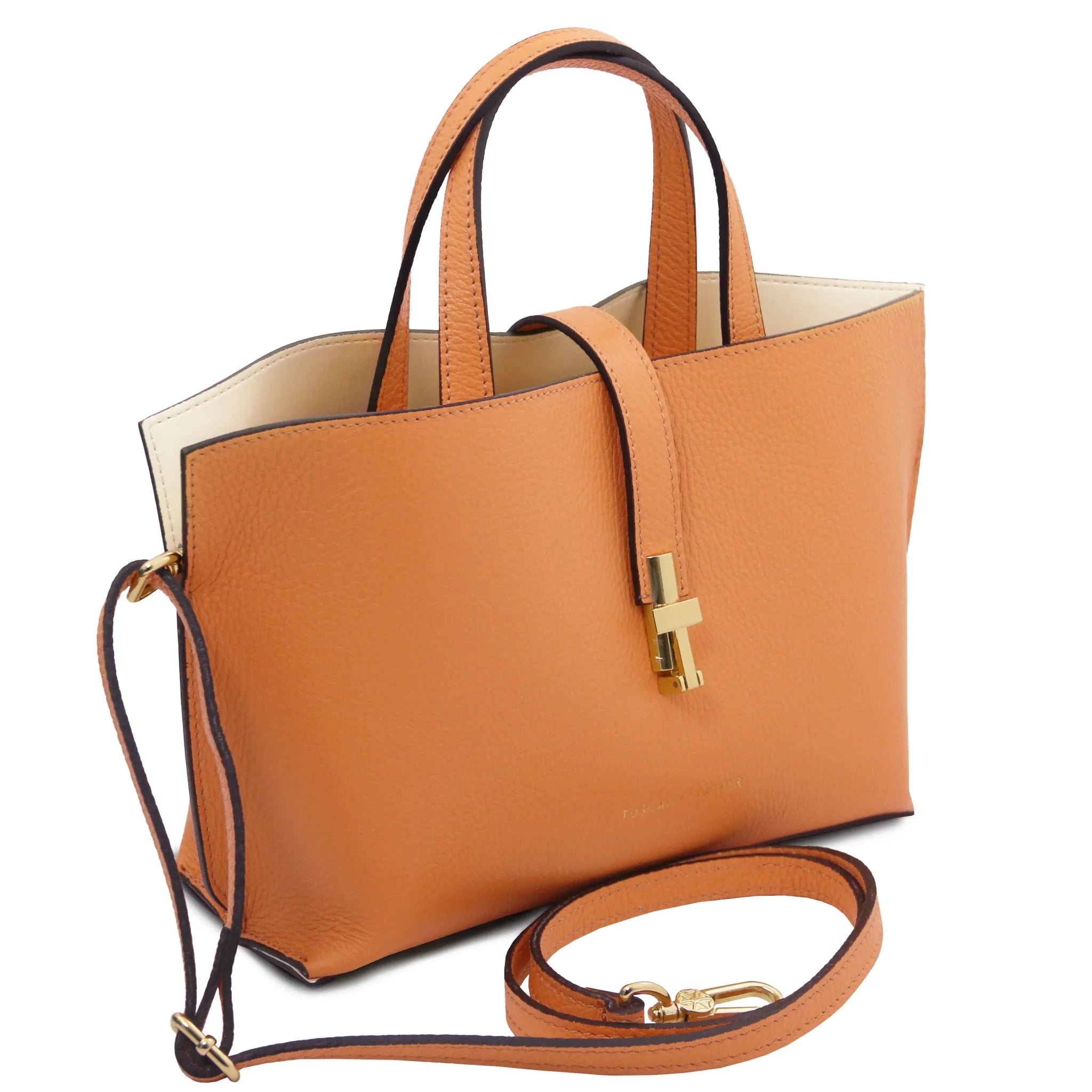 Apricot handbag with gold accents, red interiorand detachable crossbody strap on a white background