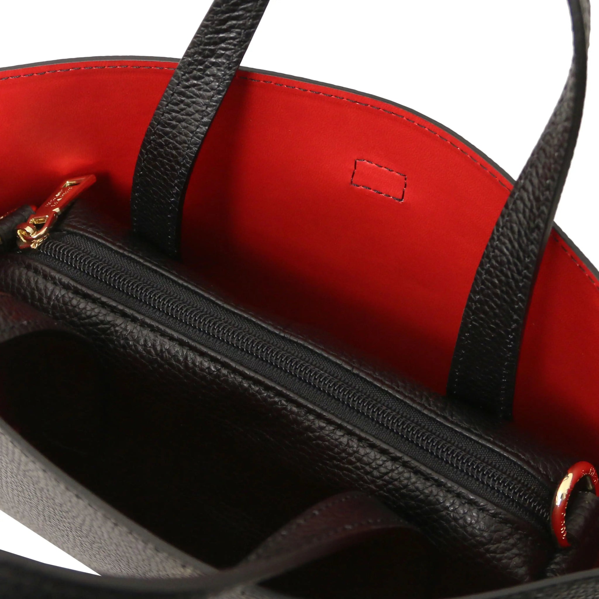 Black handbag with red interior and central zippered compartment on a white background