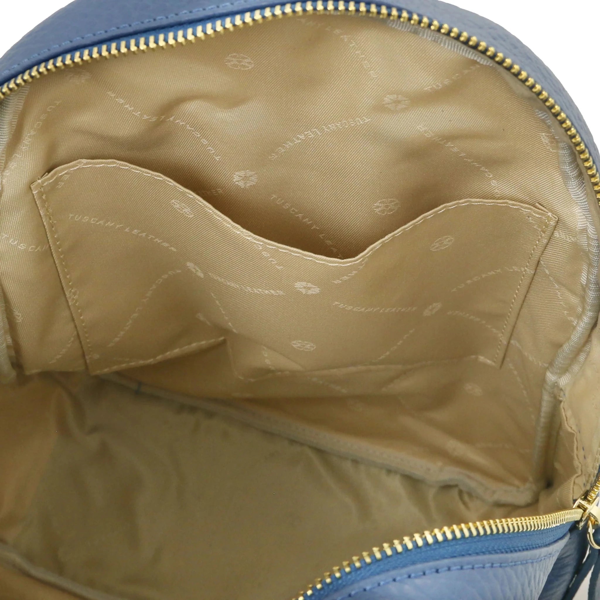 Interior open pocket view Arco Italian Pebbled Leather Backpack in Denim with beige lining