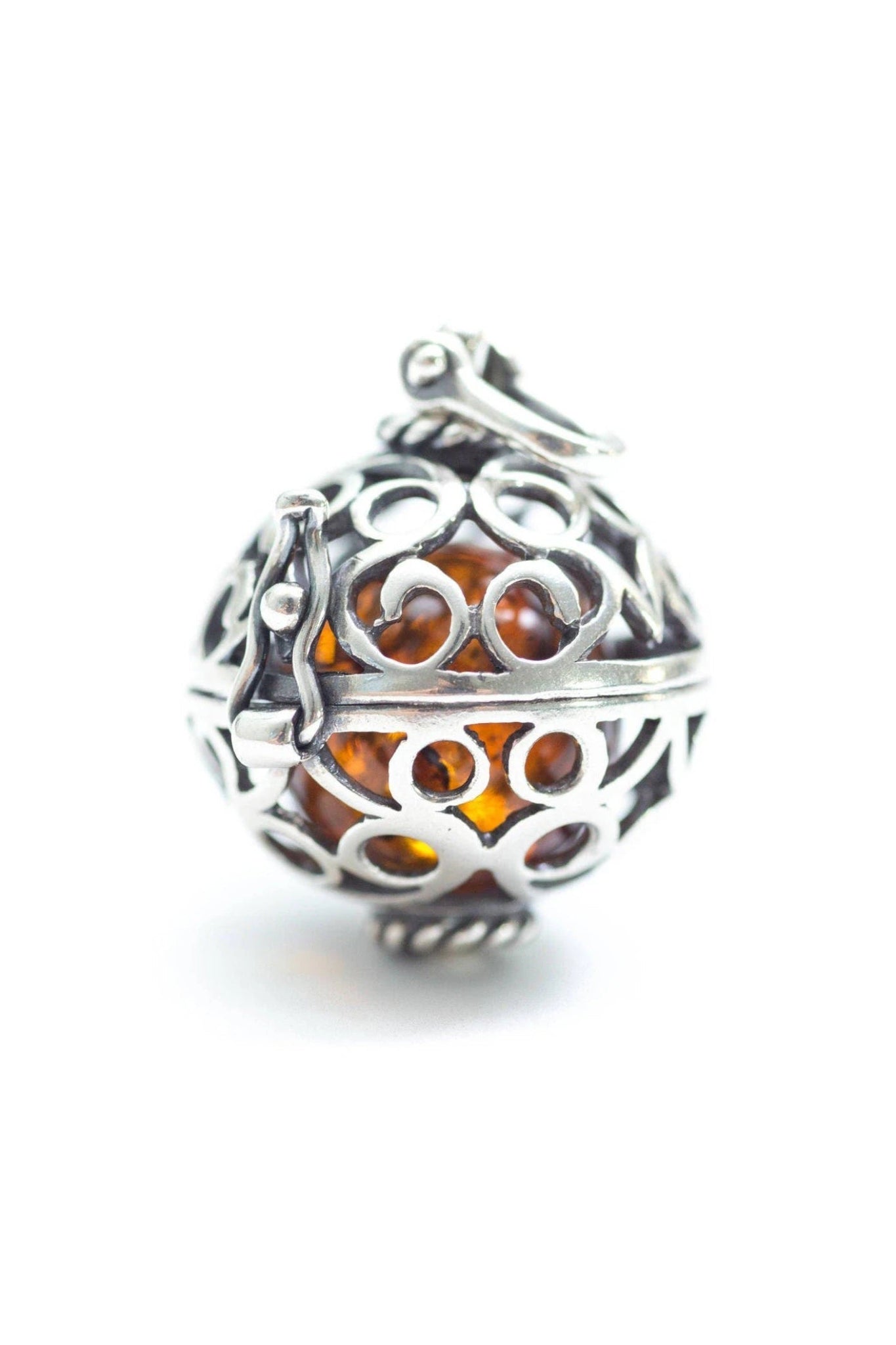 Baltic Honey Amber Sterling Silver Filigree Locket Necklace pendant is closed showing the amber ball gem that is removable inside