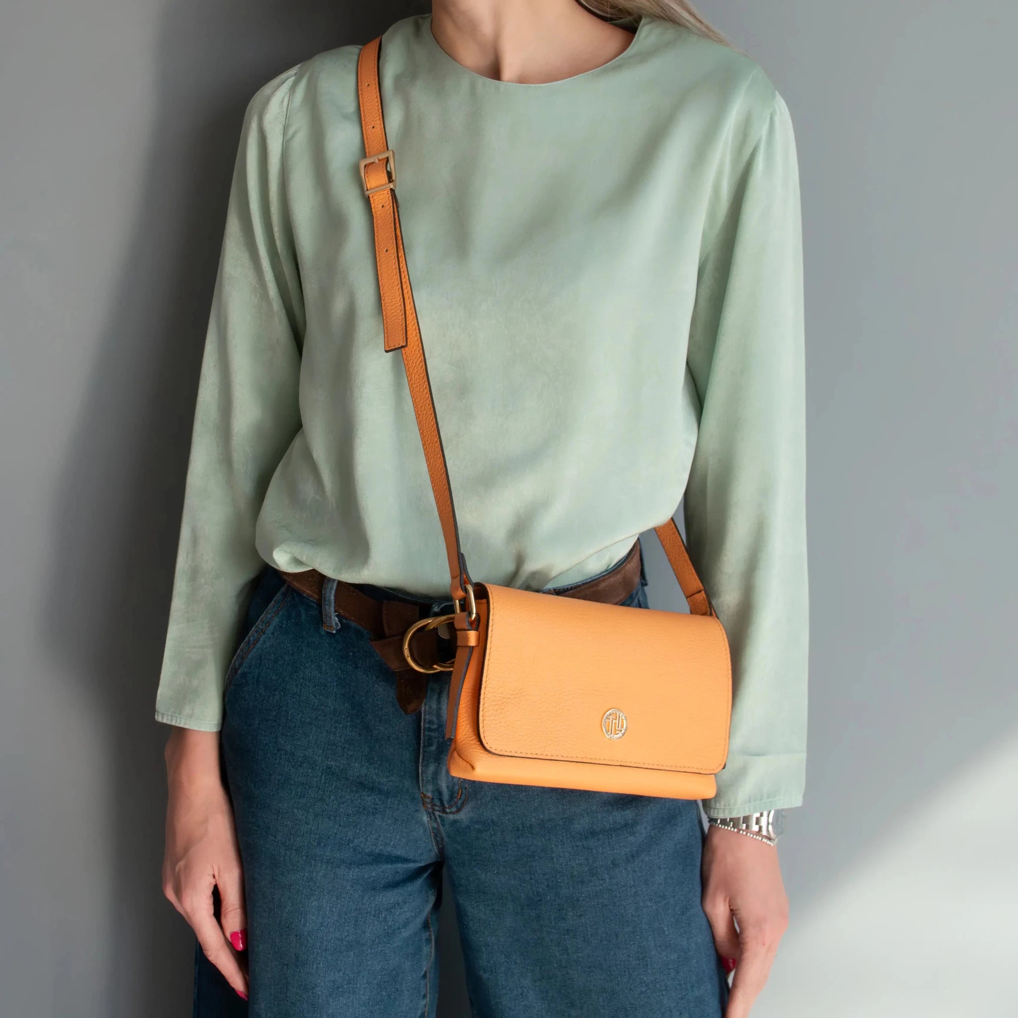 Woman wearing jeans with blue top and the Biscuit Soft Italian Leather Shoulder Bag as a crossbody bag.