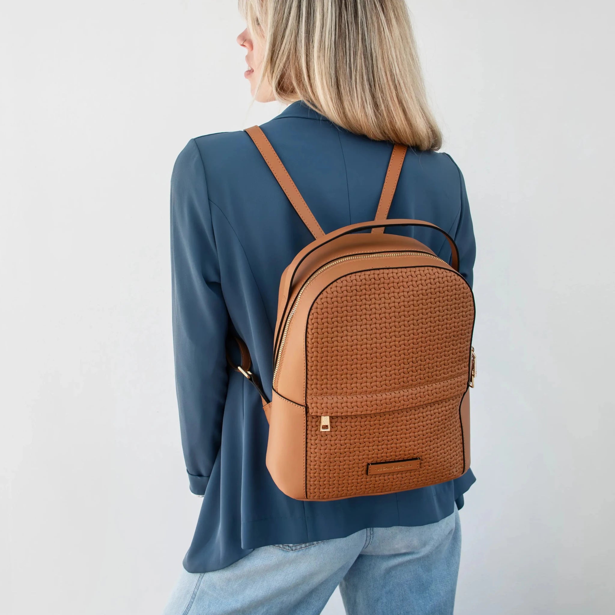 Woman wearing the  Dedalo Woven Printed Leather Backpack in cognac