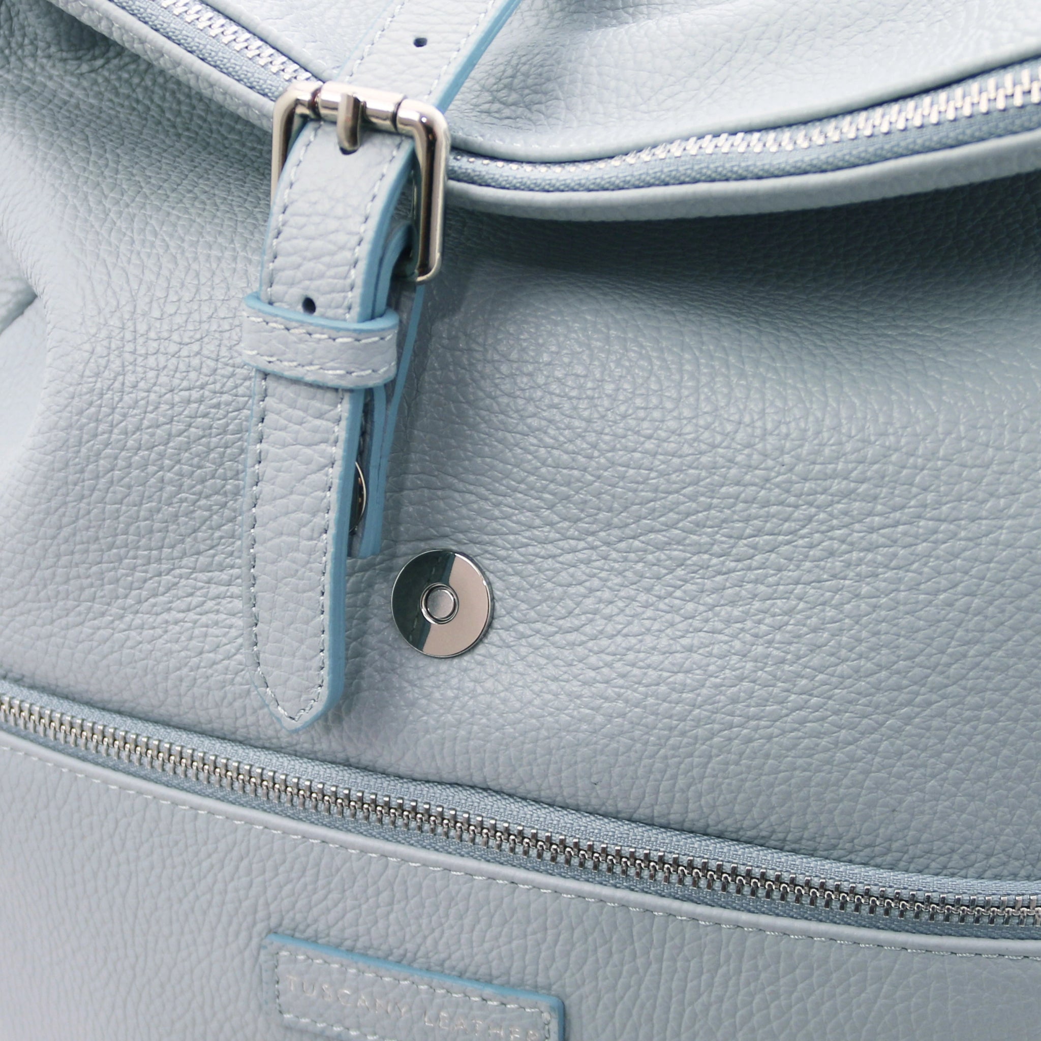 Magnetic front closure view Denver Soft Italian Leather Backpack in Light Blue, featuring the buckle decorative strap