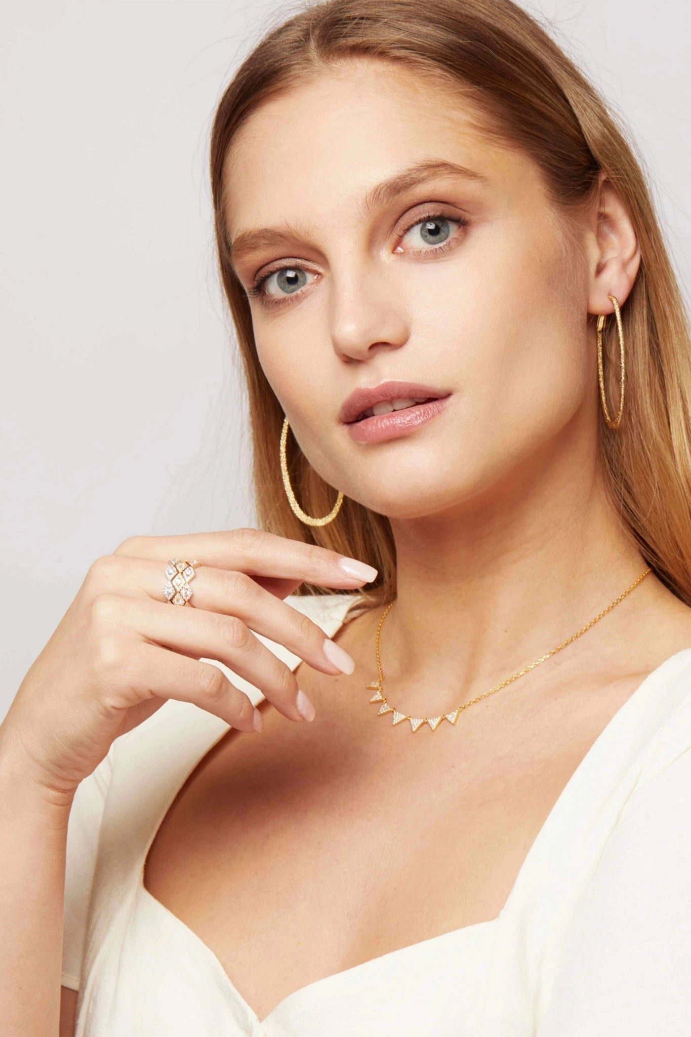 Diamonds Trio Stackable Rings on a female model with her hand held close to her face - L'Atelier Global