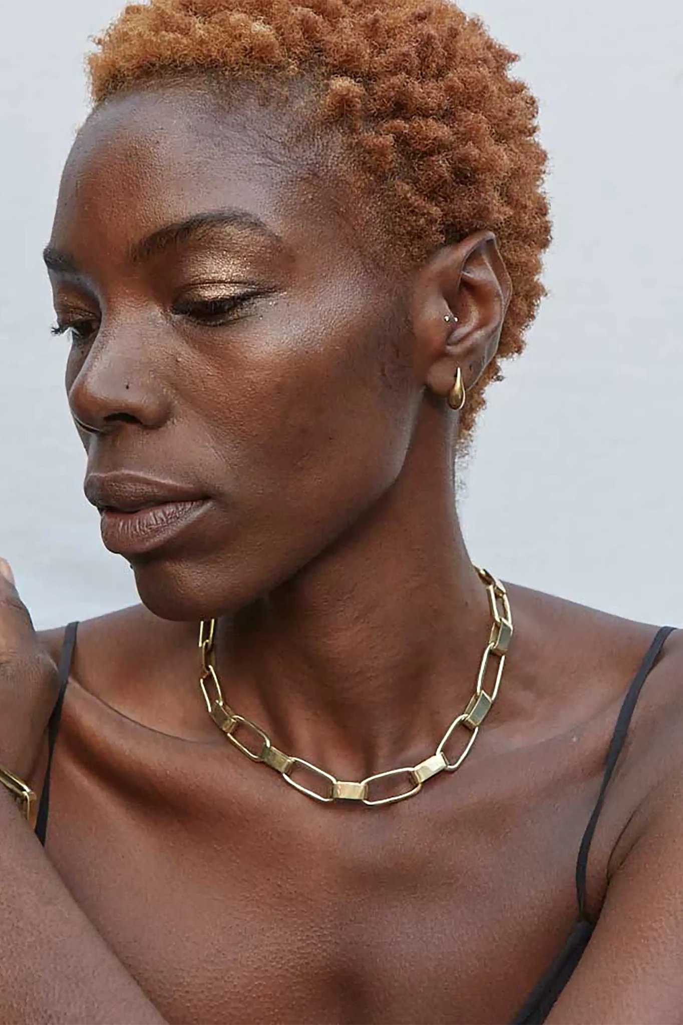 Woman wearing Kenya Capsule Chain Collar Necklace with a black tank top