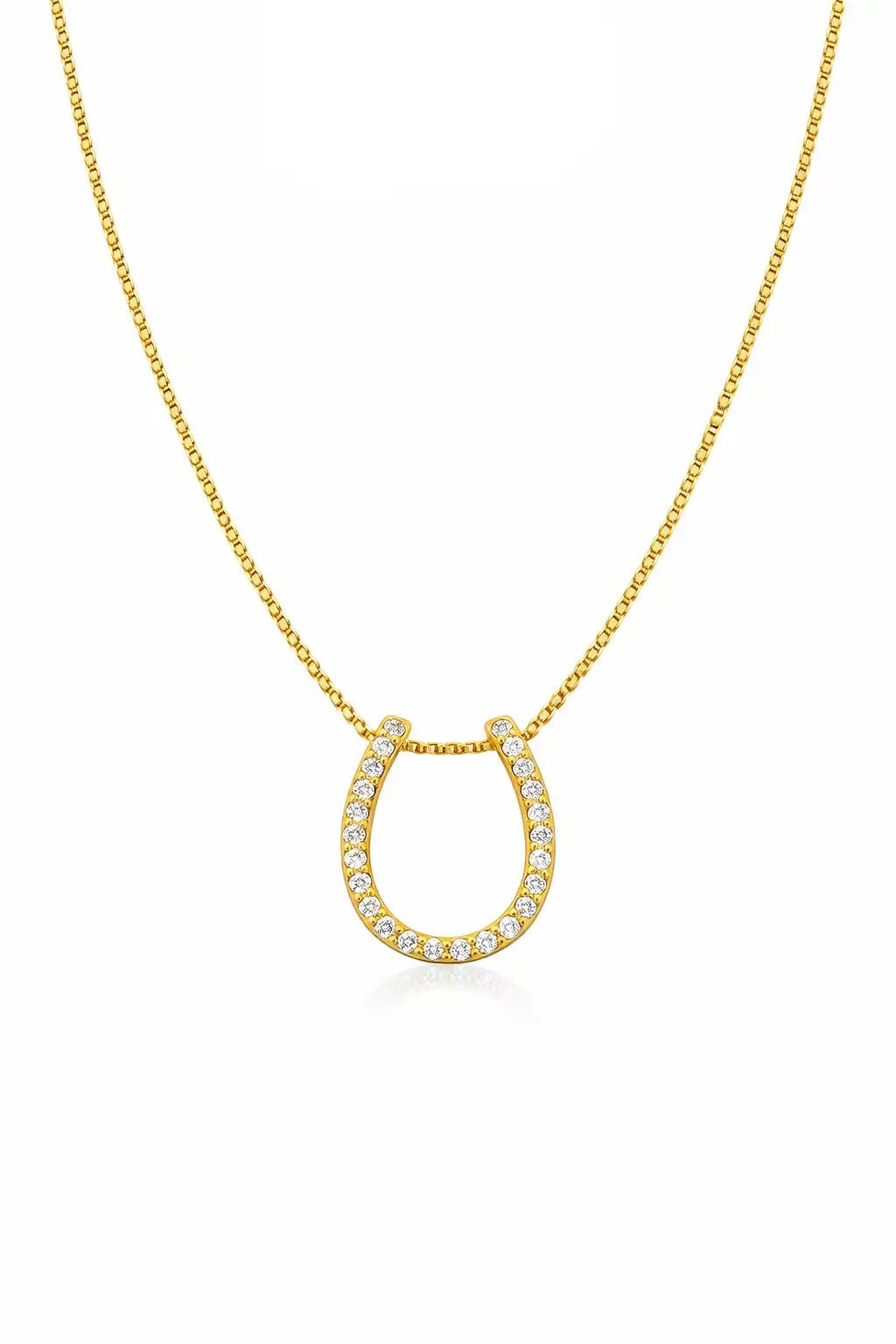 Gold necklace with a horseshoe-shaped pendant on a white background