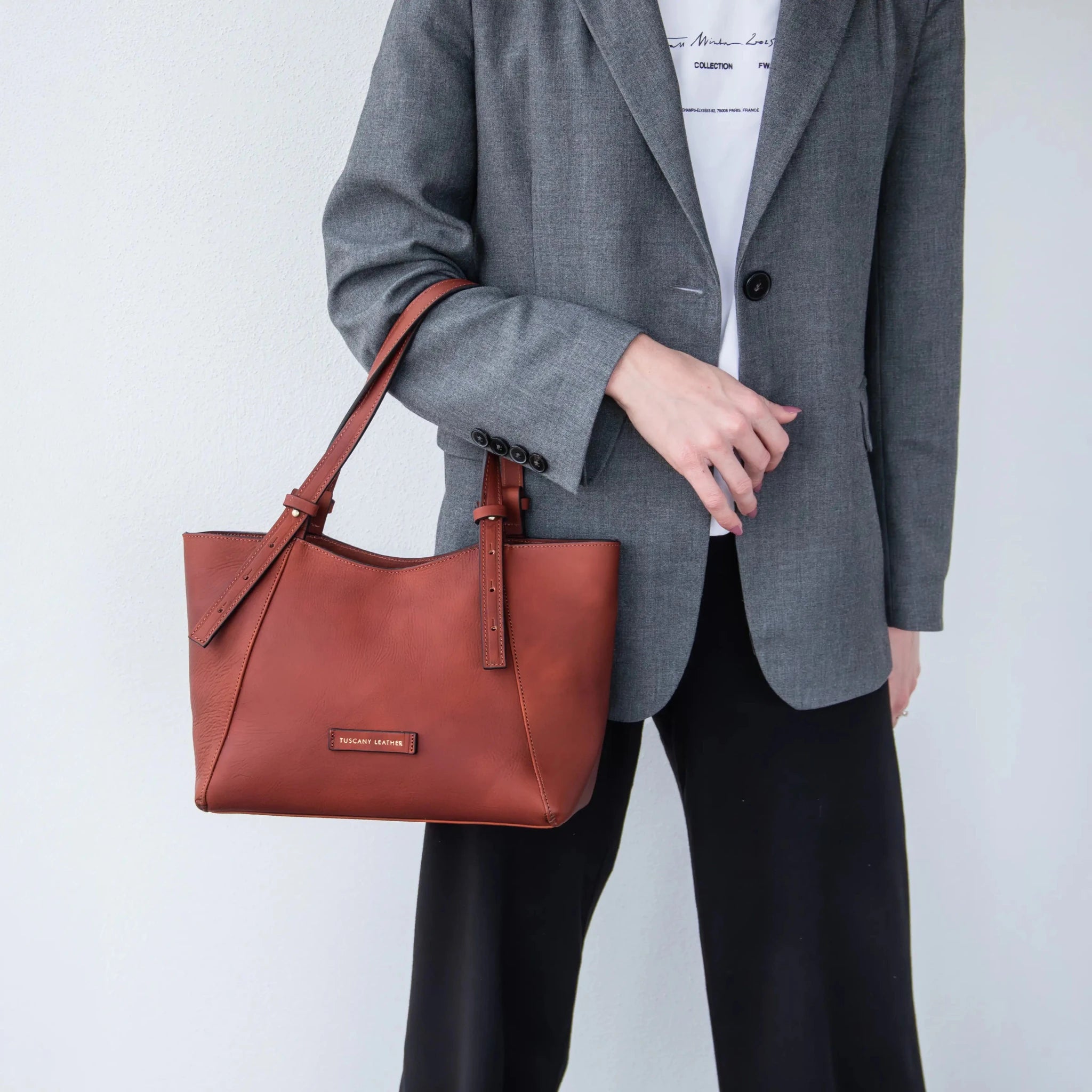 Person holding the Libra Italian Leather Shoulder Bag in red