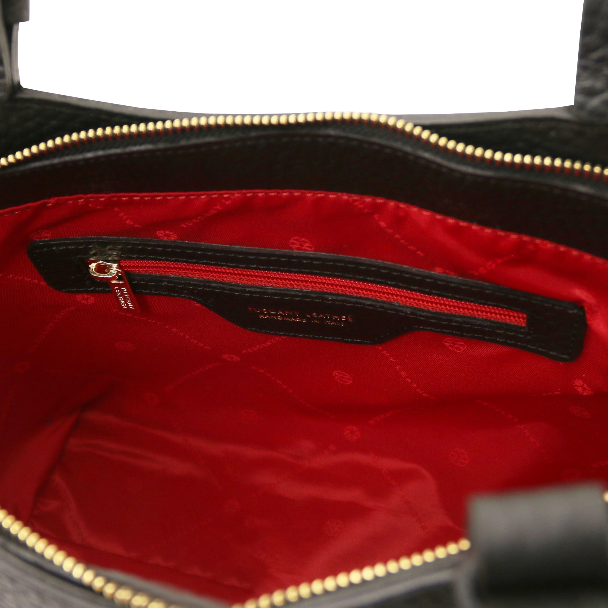 Interior zip pocket of the Libra Leather Suede Shoulder Bag in black with red lining and gold zipper.