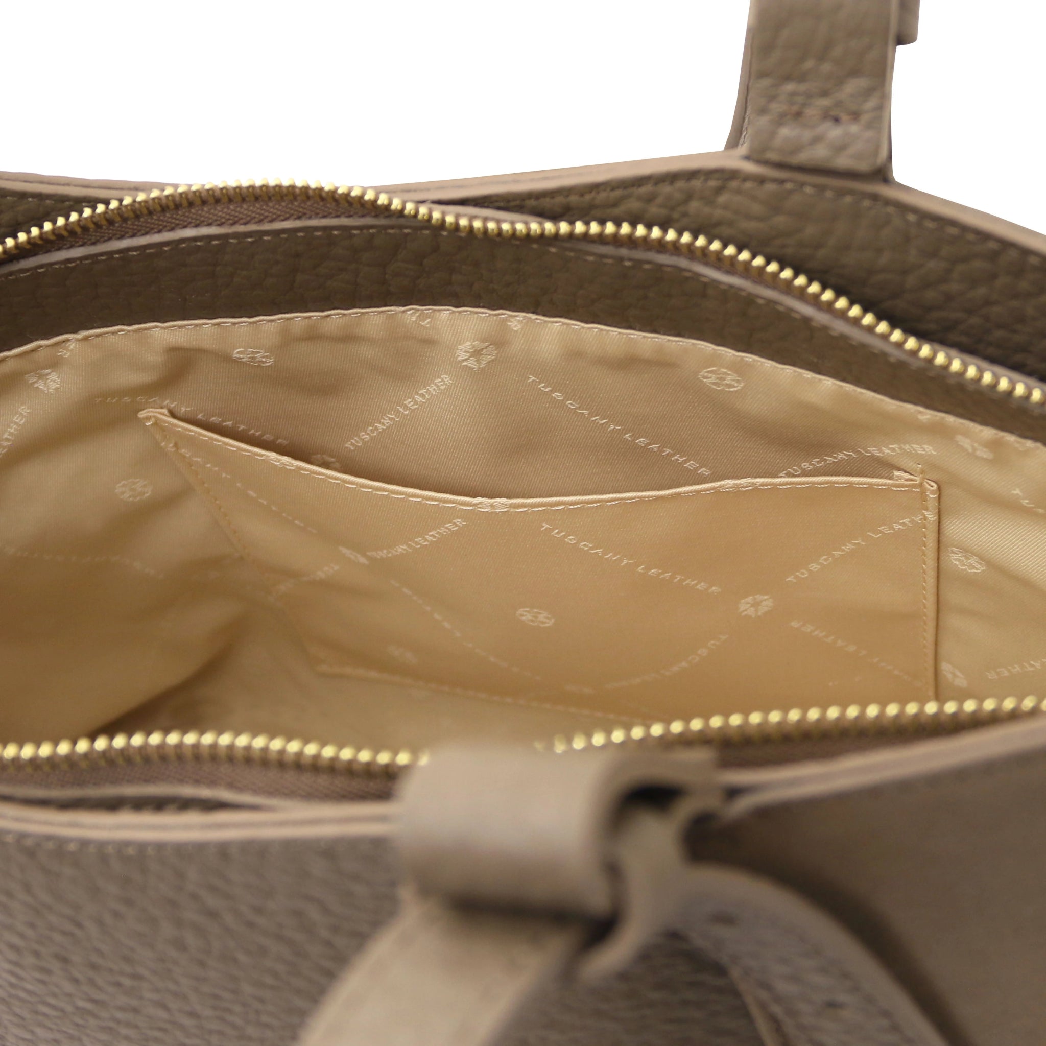 Interior of the Libra Leather Suede Shoulder Bag in dark taupe with beige lining and a slip pocket.