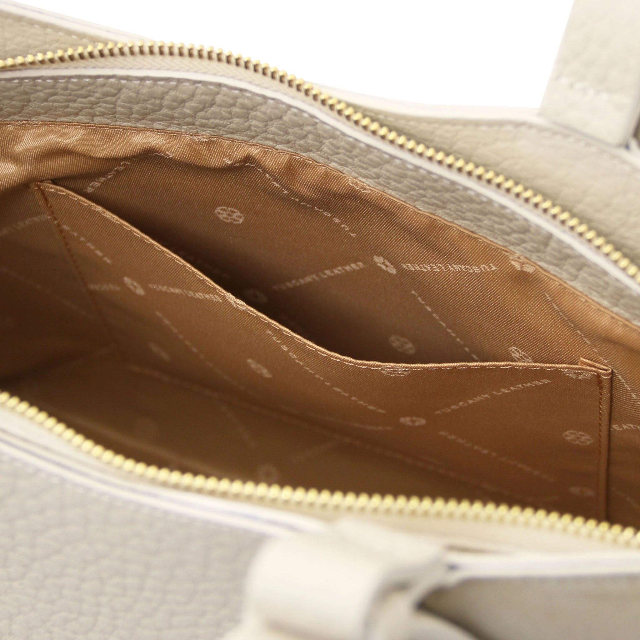 Interior of the Libra Leather Suede Shoulder Bag in beige with tan lining and a slip pocket.