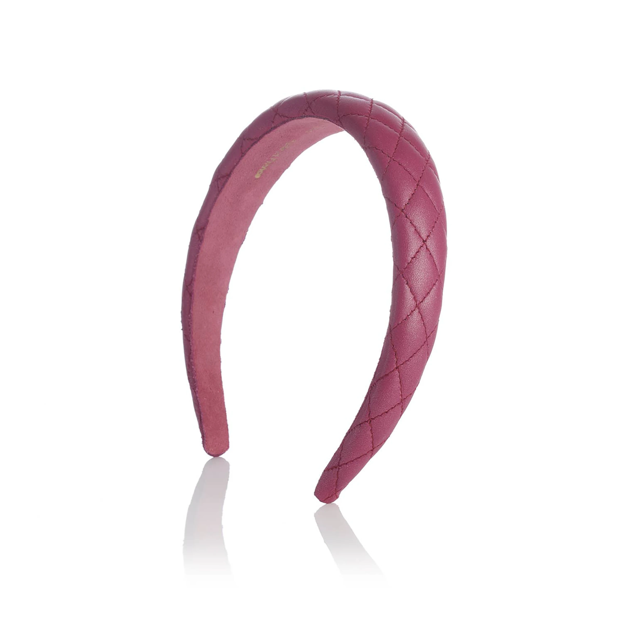 Pink quilted leather headband on a white background