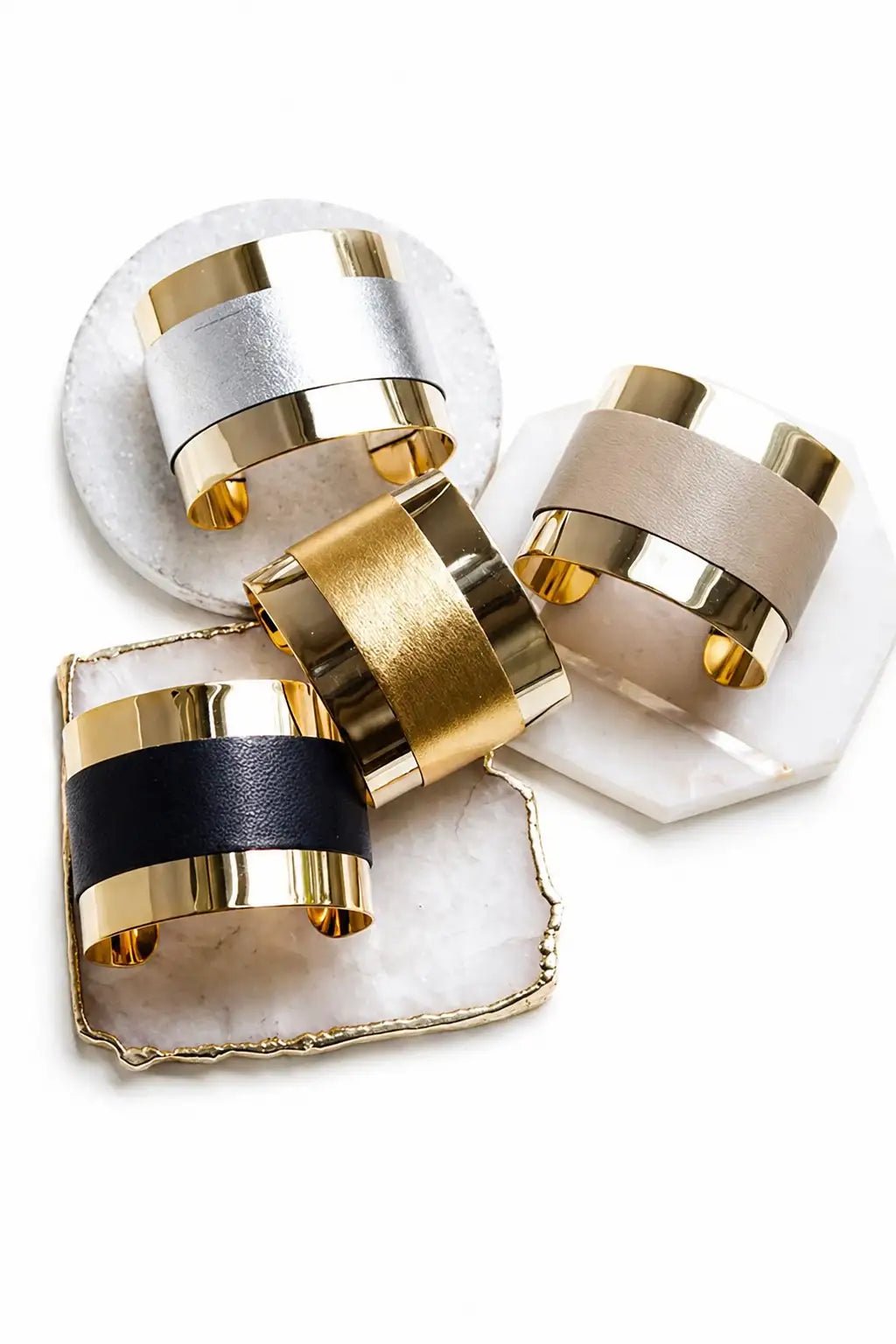 Manhattan Leather Detail Wrap Cuffs laying on coasters on a white background 