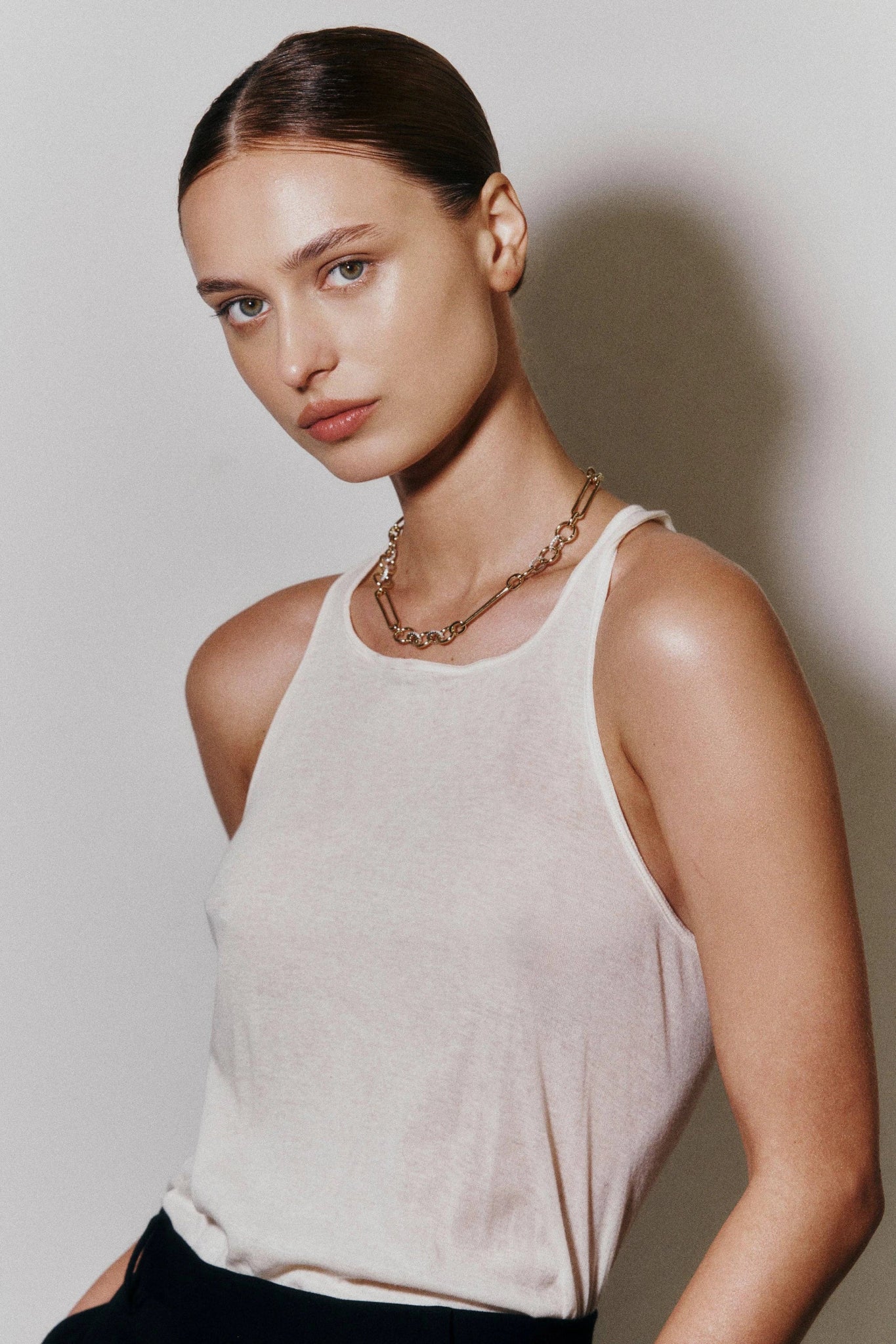 A woman wearing the Mixed Link Gold Chain White Cubic Zirconia Necklace as a choker.