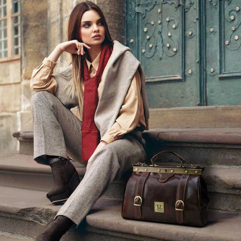 Monalisa Doctor Gladstone Italian Leather Bag in Brown on model wearing a camel wool coat and tan pants - L'Atelier Global