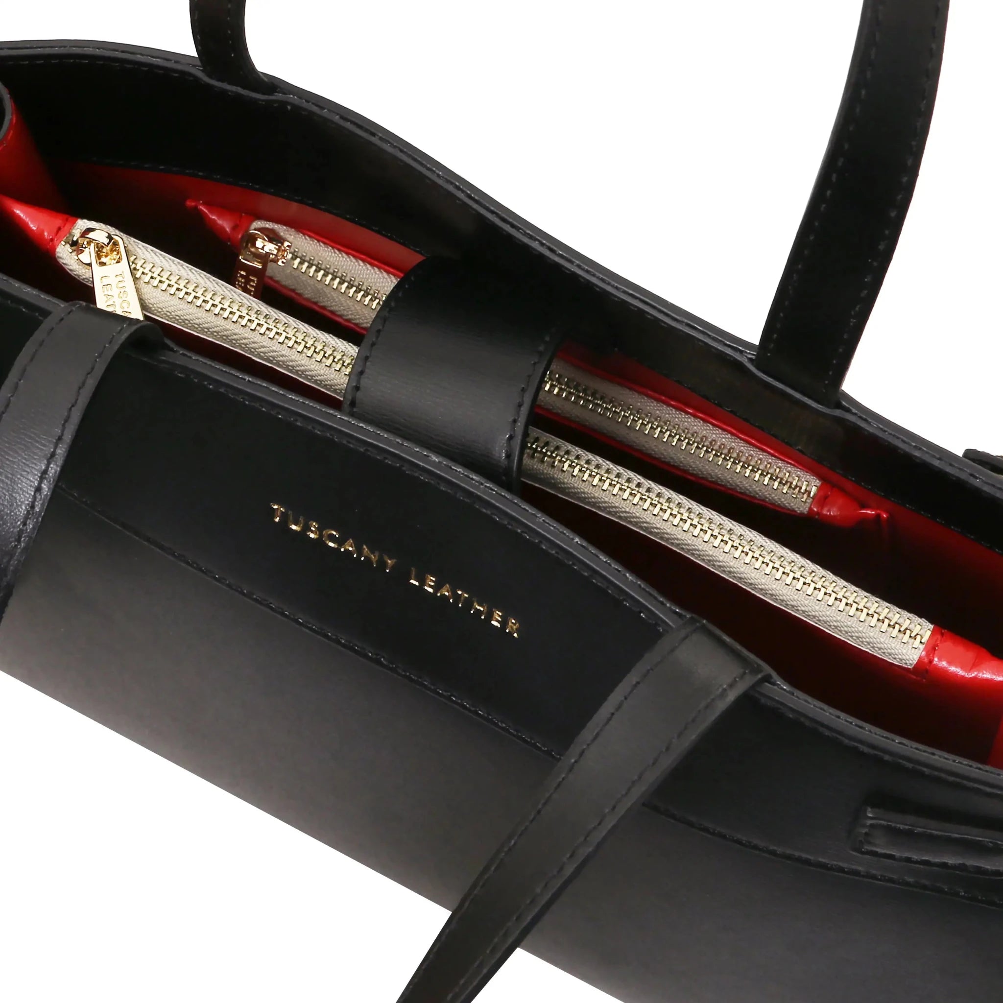 Interior zip pockets and maegnetic closure view Musa Italian Smooth Leather Tote Bag in black with red lining