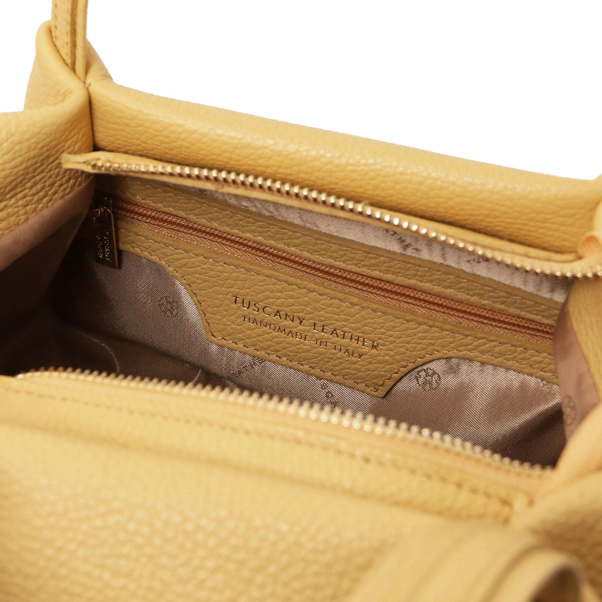 Interior zip pocket view Nora Soft Italian Leather Shoulder Bag in Yellow showing main zippered closure