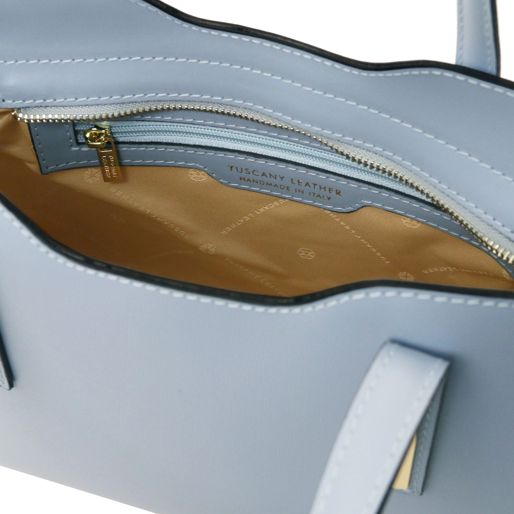 Interior Zip Pocket View Olimpia Leather Tote in Light Blue Small Size showing beige lining